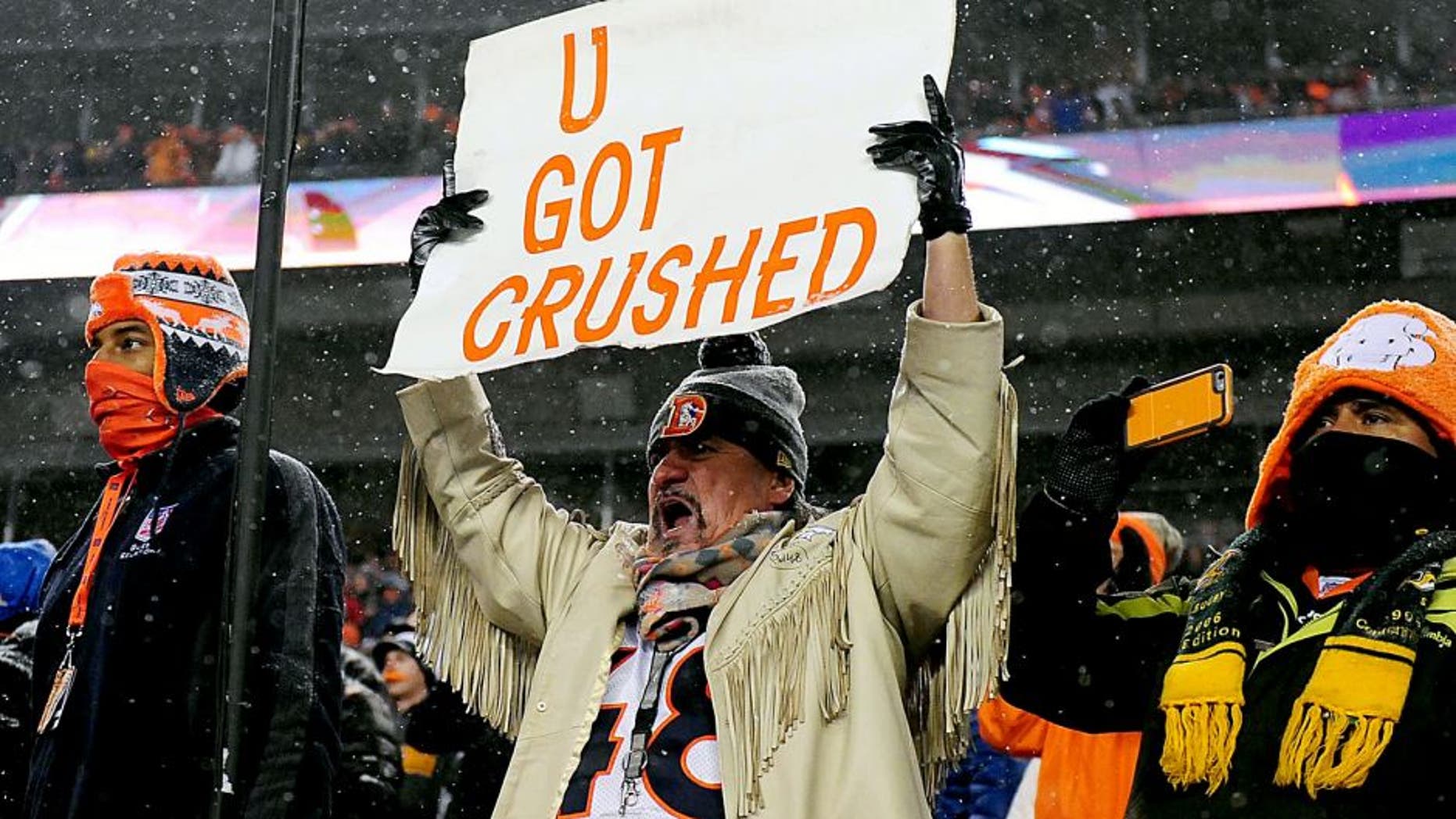 Nov 29, 2015; Denver, CO, USA; Denver Broncos fan holds a sign towards the New England Patriots bench during a overtime period at Sports Authority Field at Mile High. The Broncos defeated the Patriots 30-24 in overtime. Mandatory Credit: Ron Chenoy-USA TODAY Sports