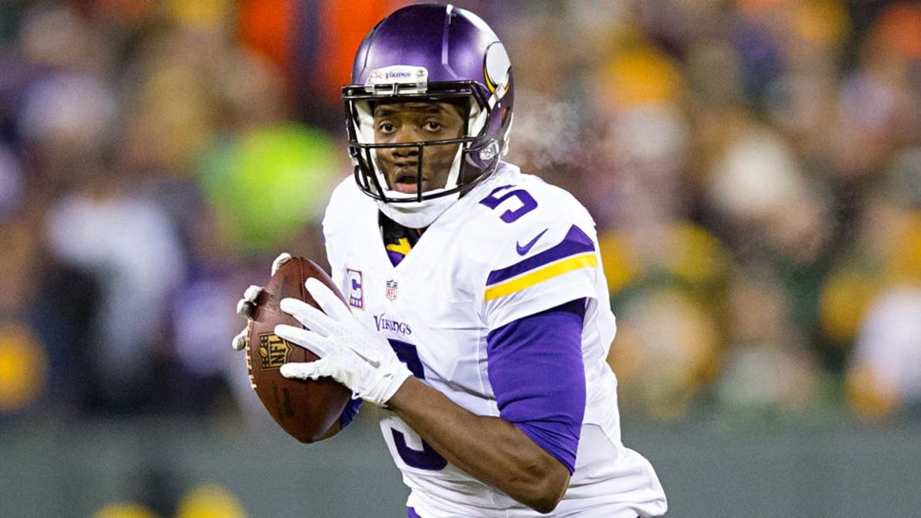 Jan 3, 2016; Green Bay, WI, USA; Minnesota Vikings quarterback Teddy Bridgewater (5) looks to pass during the first quarter against the Green Bay Packers at Lambeau Field. Mandatory Credit: Jeff Hanisch-USA TODAY Sports
