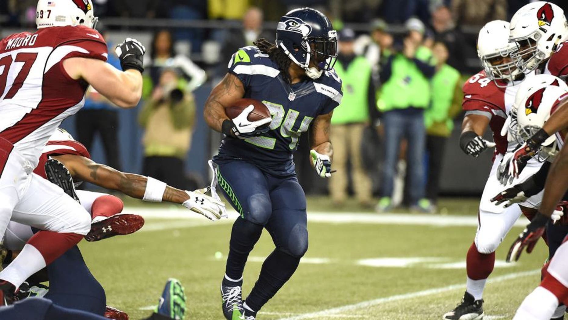 SEATTLE, WA - NOVEMBER 15: Marshawn Lynch #24 of the Seattle Seahawks carries the ball during the first half against the Arizona Cardinals at CenturyLink Field on November 15, 2015 in Seattle, Washington. (Photo by Steve Dykes/Getty Images)