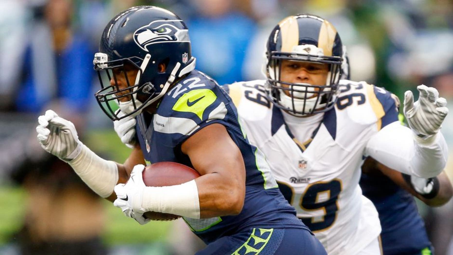 Dec 27, 2015; Seattle, WA, USA; Seattle Seahawks running back Fred Jackson (22) is tackled by St. Louis Rams defensive tackle Aaron Donald (99) during the first quarter at CenturyLink Field. Mandatory Credit: Joe Nicholson-USA TODAY Sports