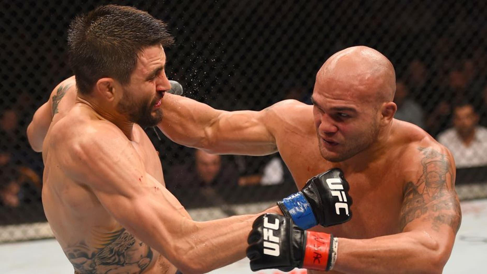 LAS VEGAS, NV - JANUARY 02: (R-L) Robbie Lawler punches Carlos Condit in their UFC welterweight championship bout during the UFC 195 event inside MGM Grand Garden Arena on January 2, 2016 in Las Vegas, Nevada. (Photo by Josh Hedges/Zuffa LLC/Zuffa LLC via Getty Images)