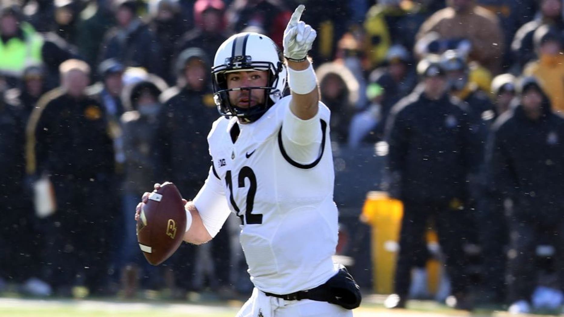 Nov 21, 2015; Iowa City, IA, USA; Purdue Boilermakers quarterback Austin Appleby (12) points downfield against the Iowa Hawkeyes during the fourth quarter at Kinnick Stadium. Iowa beat Purdue 40-20. Mandatory Credit: Reese Strickland-USA TODAY Sports