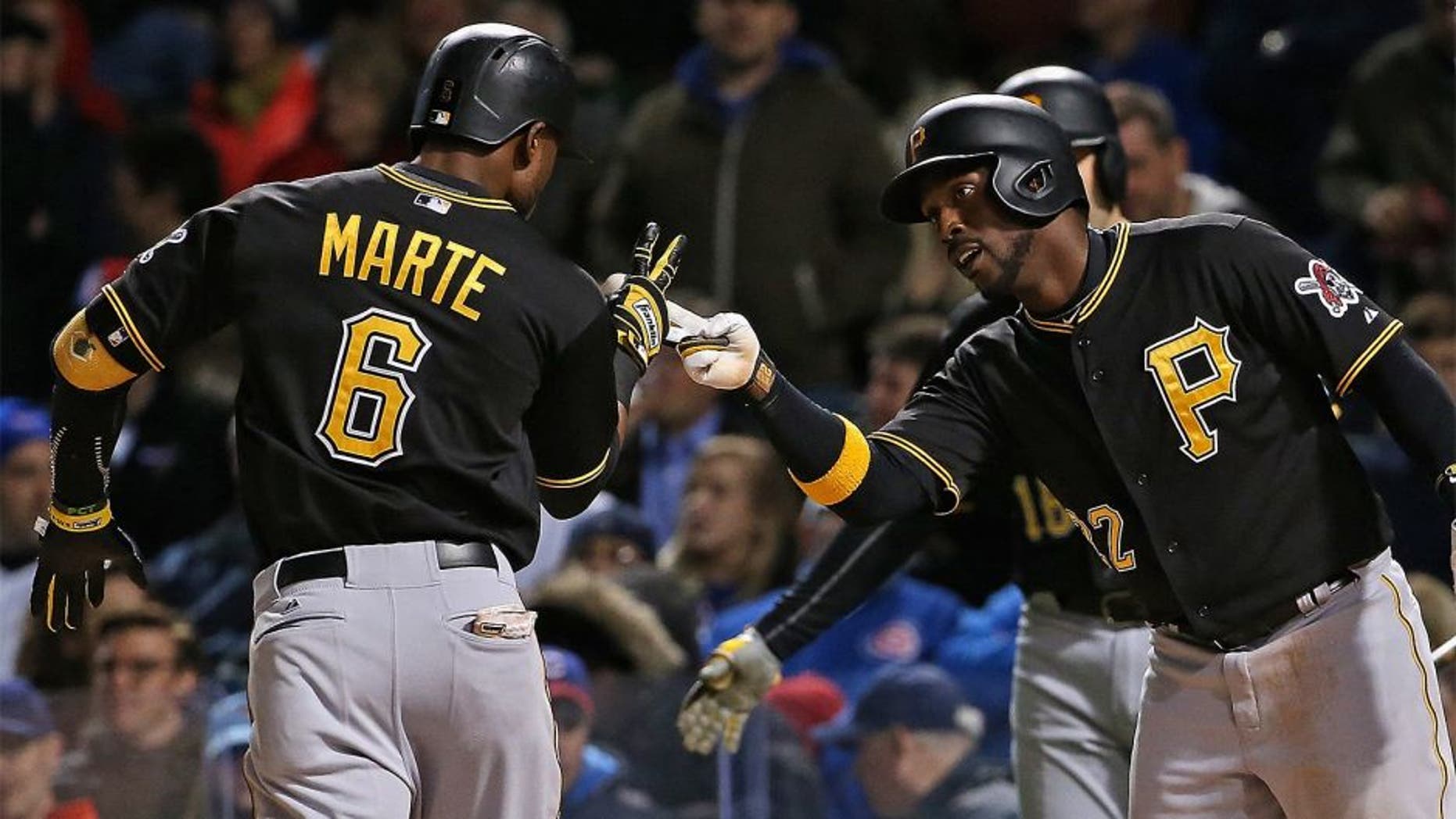 CHICAGO, IL - APRIL 28: Starling Marte #6 of the Pittsburgh Pirates is greeted by Andrew McCutchen #22 after hitting a two run home run in the 4th inning against the Chicago Cubs at Wrigley Field on April 28, 2015 in Chicago, Illinois. (Photo by Jonathan Daniel/Getty Images)