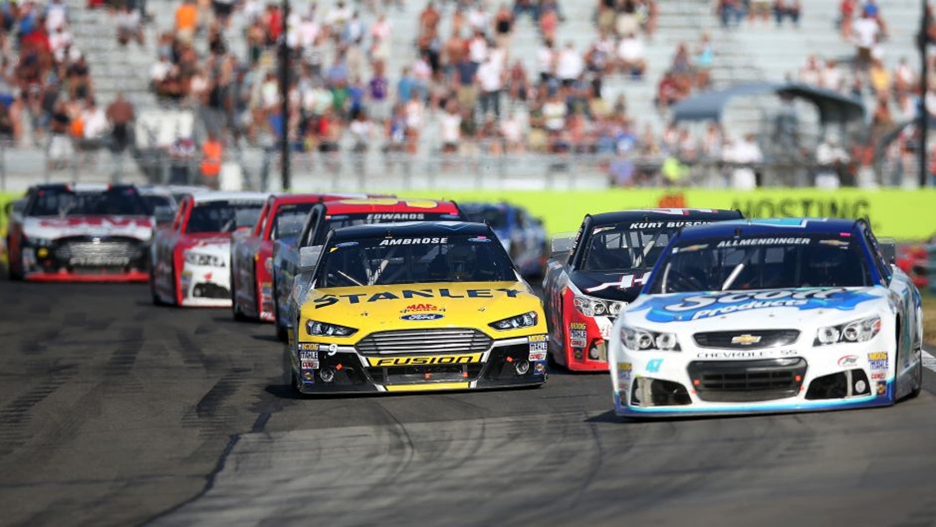 WATKINS GLEN, NY - AUGUST 10: AJ Allmendinger, driver of the #47 Scott Products Chevrolet, leads Marcos Ambrose, driver of the #9 Stanley Ford, and the field during the NASCAR Sprint Cup Series Cheez-It 355 at Watkins Glen International on August 10, 2014 in Watkins Glen, New York. (Photo by Chris Graythen/NASCAR via Getty Images)