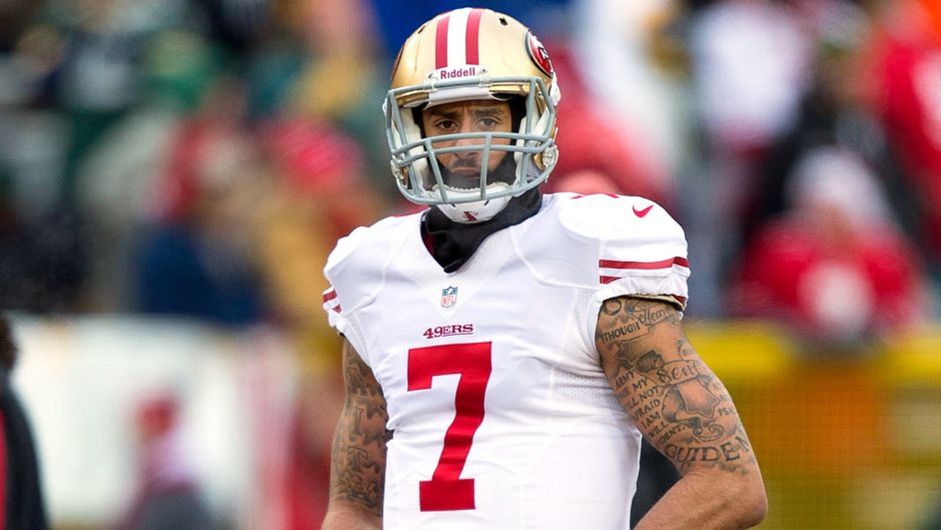 Jan 5, 2014; Green Bay, WI, USA; San Francisco 49ers quarterback Colin Kaepernick (7) walks on the field prior to the 2013 NFC wild card playoff football game against the Green Bay Packers at Lambeau Field. Mandatory Credit: Jeff Hanisch-USA TODAY Sports