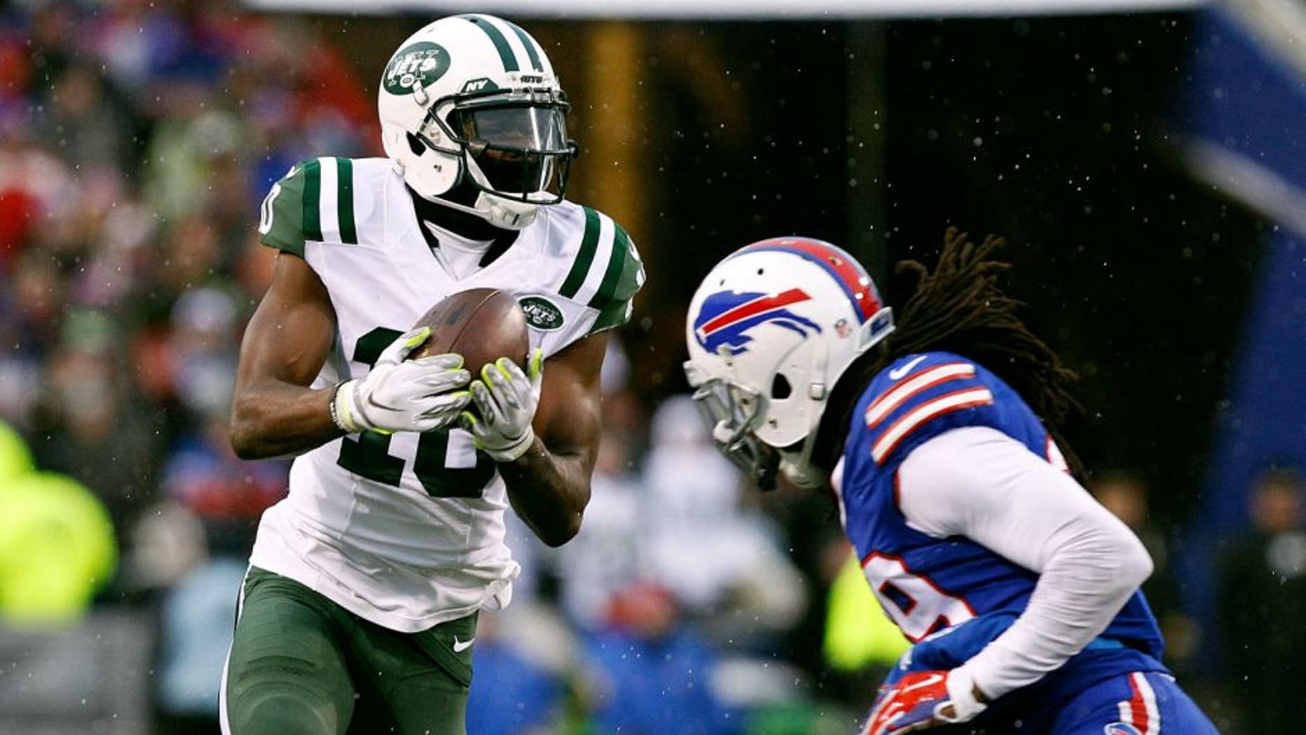 Jan 3, 2016; Orchard Park, NY, USA; New York Jets wide receiver Kenbrell Thompkins (10) cannot hold on to this pass late in the game as Buffalo Bills running back Karlos Williams (29) defends during the second half at Ralph Wilson Stadium. Bills beat the Jets 22-17. Mandatory Credit: Kevin Hoffman-USA TODAY Sports
