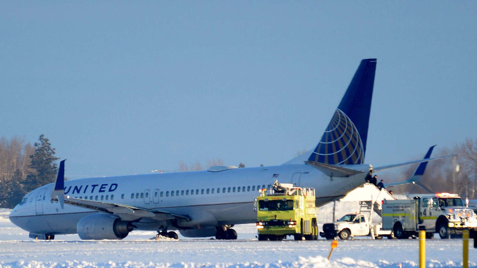 Jan. 5, 2016: Emergency vehicles surround a United Airlines aircraft as passengers wait to be evacuated at the Spokane International Airport in Spokane, Wash.
