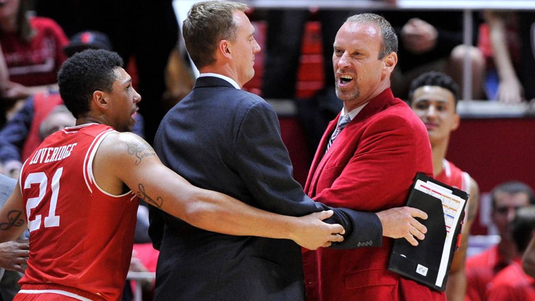 SALT LAKE CITY, UT - DECEMBER 2: Jordan Loveridge #21, assistant coach Phil Cullen of the Utah Utes, restrain head coach Larry Krystkowiak of the Utah Utes after an on court incident against the Brigham Young Cougars at the Jon M. Huntsman Center on December 2, 2015 in Salt Lake City, Utah. (Photo by Gene Sweeney Jr/Getty Images)