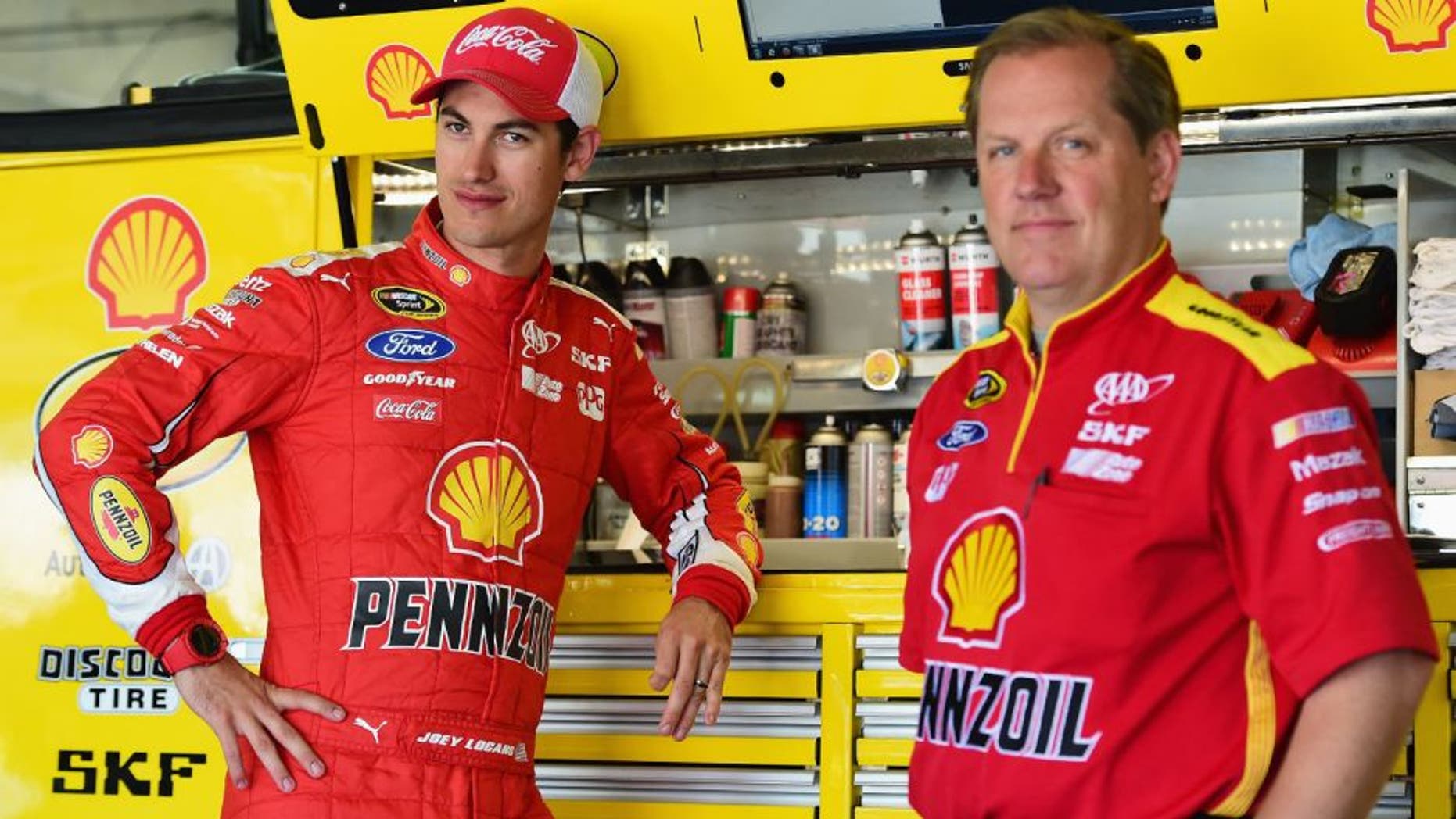 CHARLOTTE, NC - MAY 23: Joey Logano, driver of the #22 Shell Pennzoil Ford, stands in the garage area with his crew chief Todd Gordon during practice for the NASCAR Sprint Cup Series Coca-Cola 600 at Charlotte Motor Speedway on May 23, 2015 in Charlotte, North Carolina. (Photo by Jared C. Tilton/Getty Images)