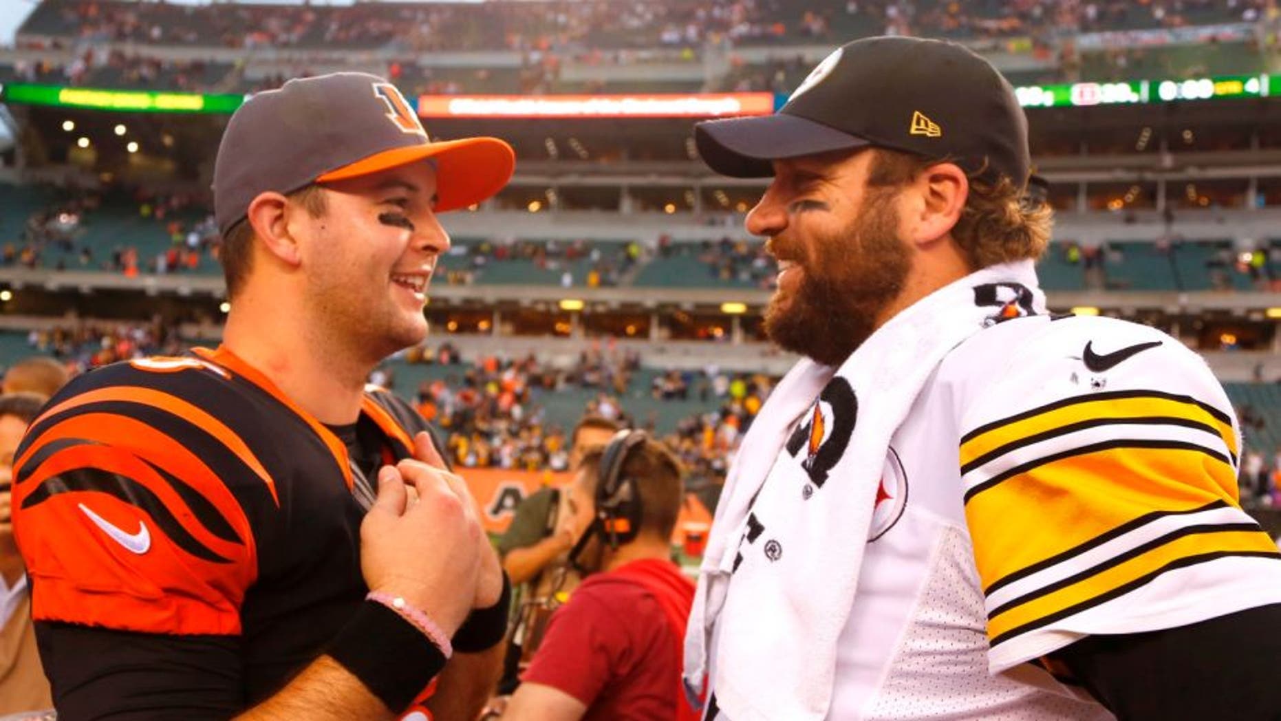Dec 13, 2015; Cincinnati, OH, USA; Pittsburgh Steelers quarterback Ben Roethlisberger (R) talks with Cincinnati Bengals quarterback AJ McCarron (L) after the Steelers beat the Bengals 33-20 at Paul Brown Stadium. Mandatory Credit: David Kohl-USA TODAY Sports