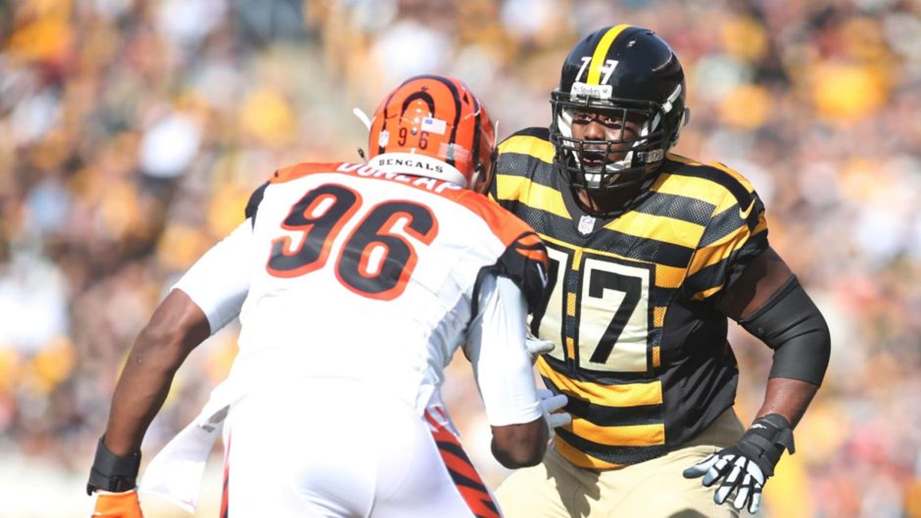 Nov 1, 2015; Pittsburgh, PA, USA; Pittsburgh Steelers tackle Marcus Gilbert (77) blocks at the line of scrimmage against Cincinnati Bengals defensive end Carlos Dunlap (96) at Heinz Field. The Bengals won 16-10. Mandatory Credit: Charles LeClaire-USA TODAY Sports