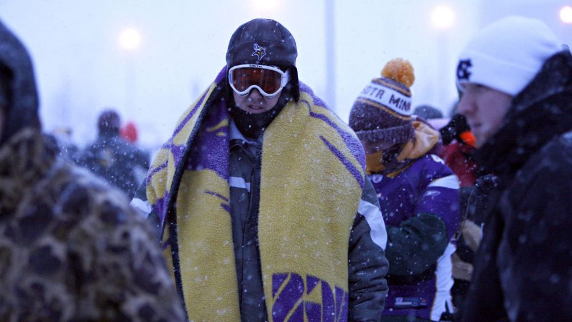 Snow continues to fall, as fans arrive at TCF Bank Stadium for the Minnesota Vikings' game against the Chicago Bears in Minneapolis, Minnesota, Monday, December 20, 2010. (Brian Cassella/Chicago Tribune/MCT via Getty Images)