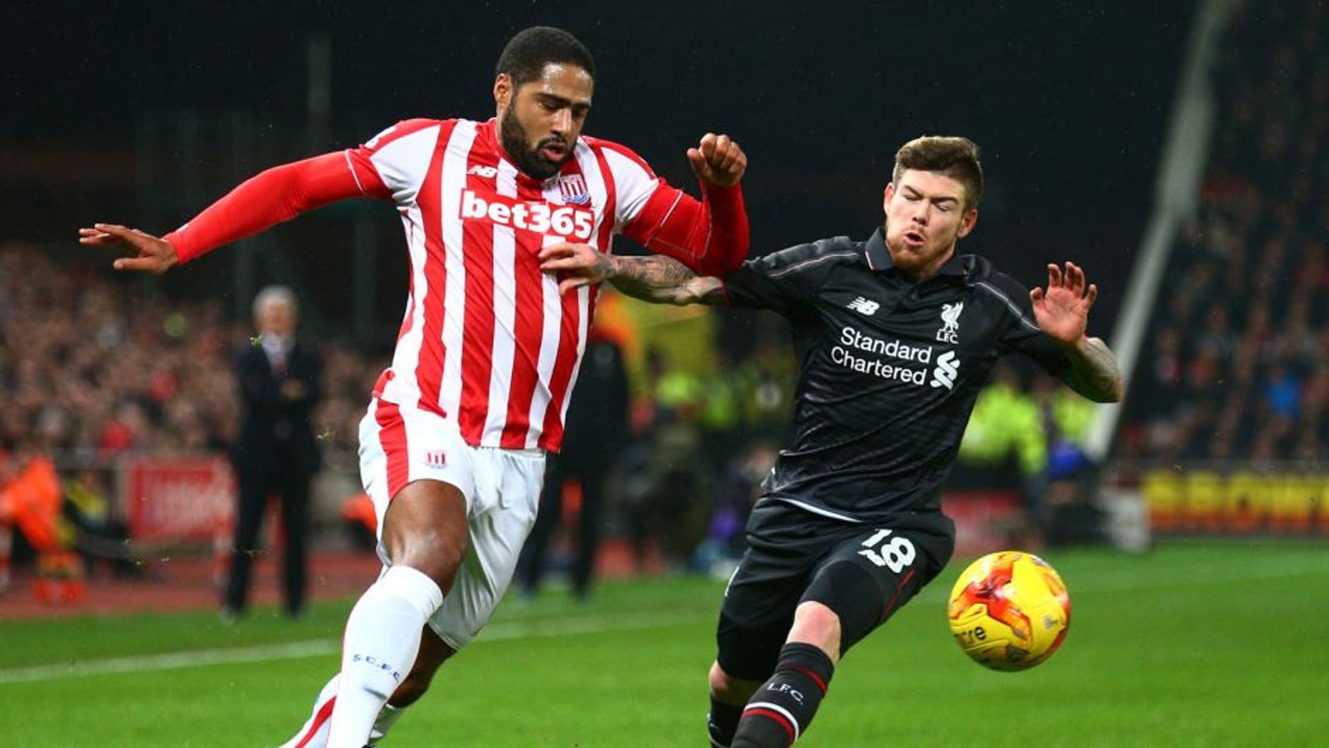 STOKE ON TRENT, ENGLAND - JANUARY 05: Glen Johnson of Stoke City and Alberto Moreno of Liverpool battle for the ball during the Capital One Cup semi final, first leg match between Stoke City and Liverpool at the Britannia Stadium on January 5, 2016 in Stoke on Trent, England. (Photo by Clive Mason/Getty Images)