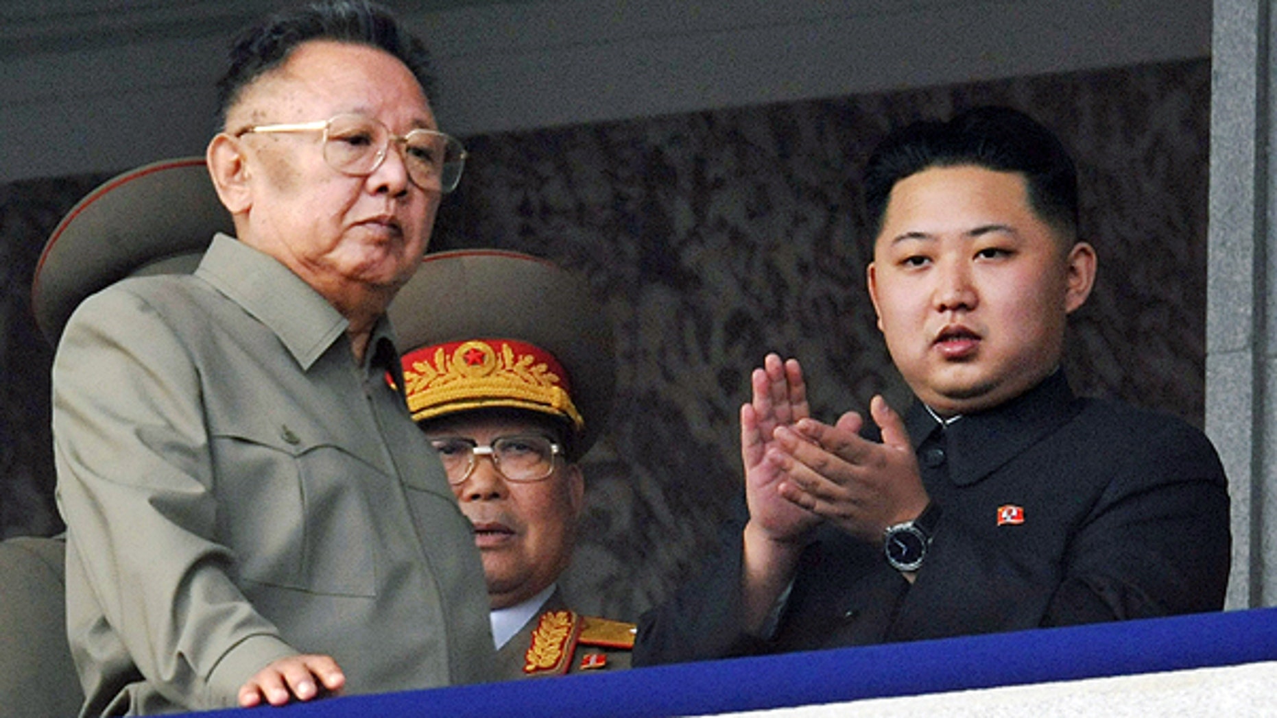 In this Oct. 10, 2010 file photo North Korea leader Kim Jong Il, left, walks by his son Kim Jong Un on the balcony as they attend a massive military parade marking the 65th anniversary of the communist nation's ruling Workers' Party in Pyongyang, North Korea.