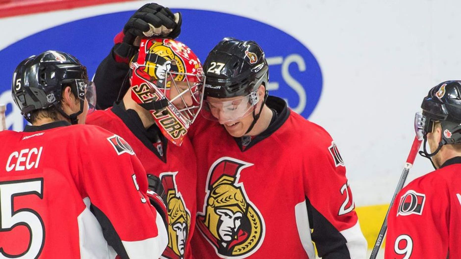 Oct 16, 2014; Ottawa, Ontario, CAN; Ottawa Senators goalie Craig Anderson (41) is congratulated by center Curtis Lazar (27) following their win against the Colorado Avalanche at the Canadian Tire Centre. The Senators defeated the Colorado Avalanche 5-3. Mandatory Credit: Marc DesRosiers-USA TODAY Sports
