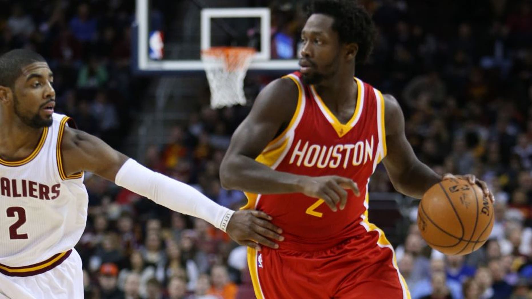 Jan 7, 2015; Cleveland, OH, USA; Houston Rockets guard Patrick Beverley (2) drives around Cleveland Cavaliers guard Kyrie Irving (2) during the second quarter at Quicken Loans Arena. Mandatory Credit: Ron Schwane-USA TODAY Sports