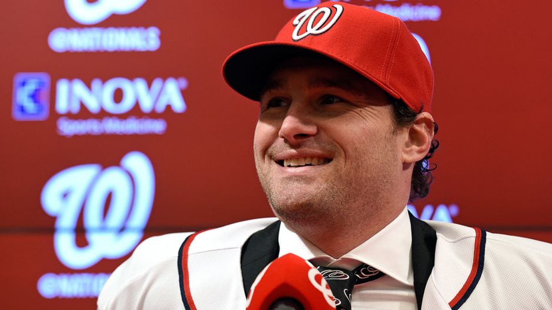New Washington Nationals infielder Daniel Murphy speaks during a news conference at Nationals Park in Washington, Thursday, Jan. 7, 2016. Murphy's three-year contract with the Nationals will cost the team only $8 million in 2016. (AP Photo/Susan Walsh)