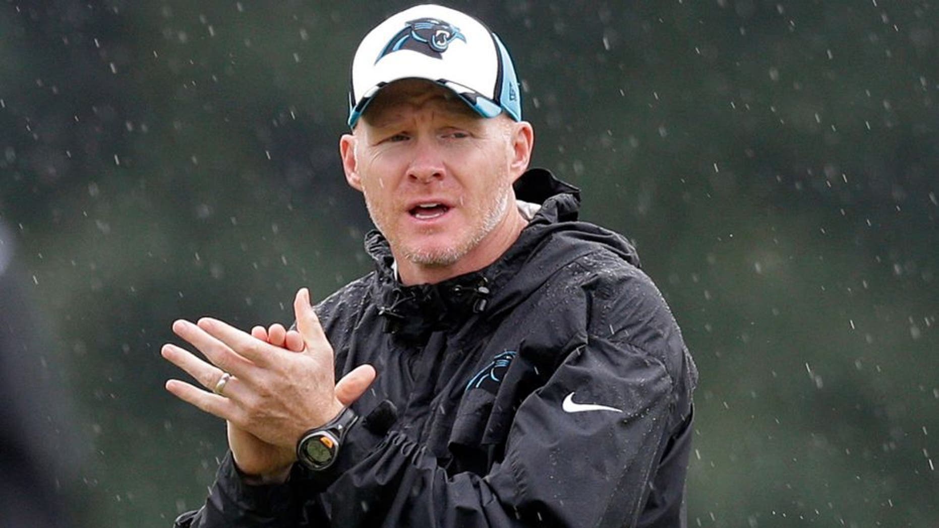 FILE - In this July 31, 2014, file photo, Carolina Panthers defensive coordinator Sean McDermott applauds the defense during an NFL football practice at their training camp in Spartanburg, S.C. The Browns are interviewing Carolina defensive coordinator Sean McDermott and Jacksonville offensive assistant Doug Marrone for their head coaching job. (AP Photo/Chuck Burton, File)