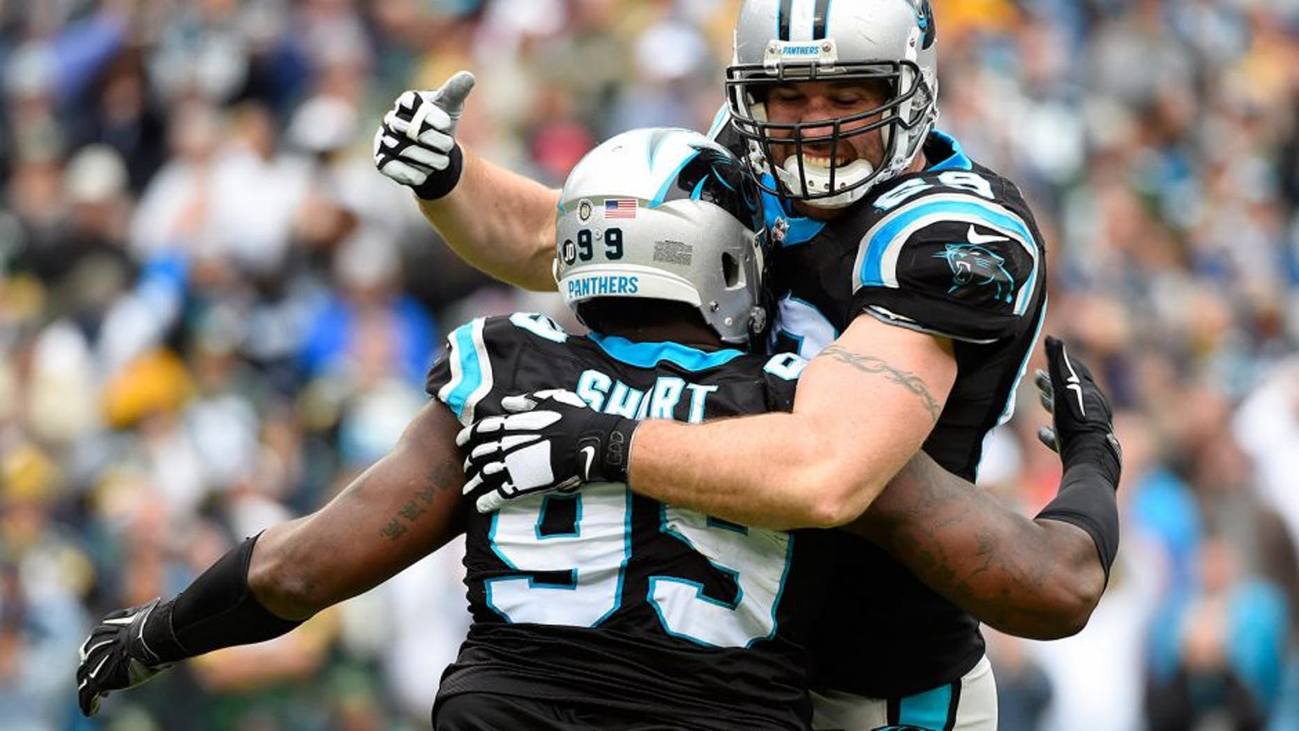 Nov 8, 2015; Charlotte, NC, USA; Carolina Panthers defensive tackle Kawann Short (99) celebrates with defensive end Jared Allen (69) after sacking Green Bay Packers quarterback Aaron Rodgers (12) (not pictured) in the second quarter at Bank of America Stadium. Mandatory Credit: Bob Donnan-USA TODAY Sports