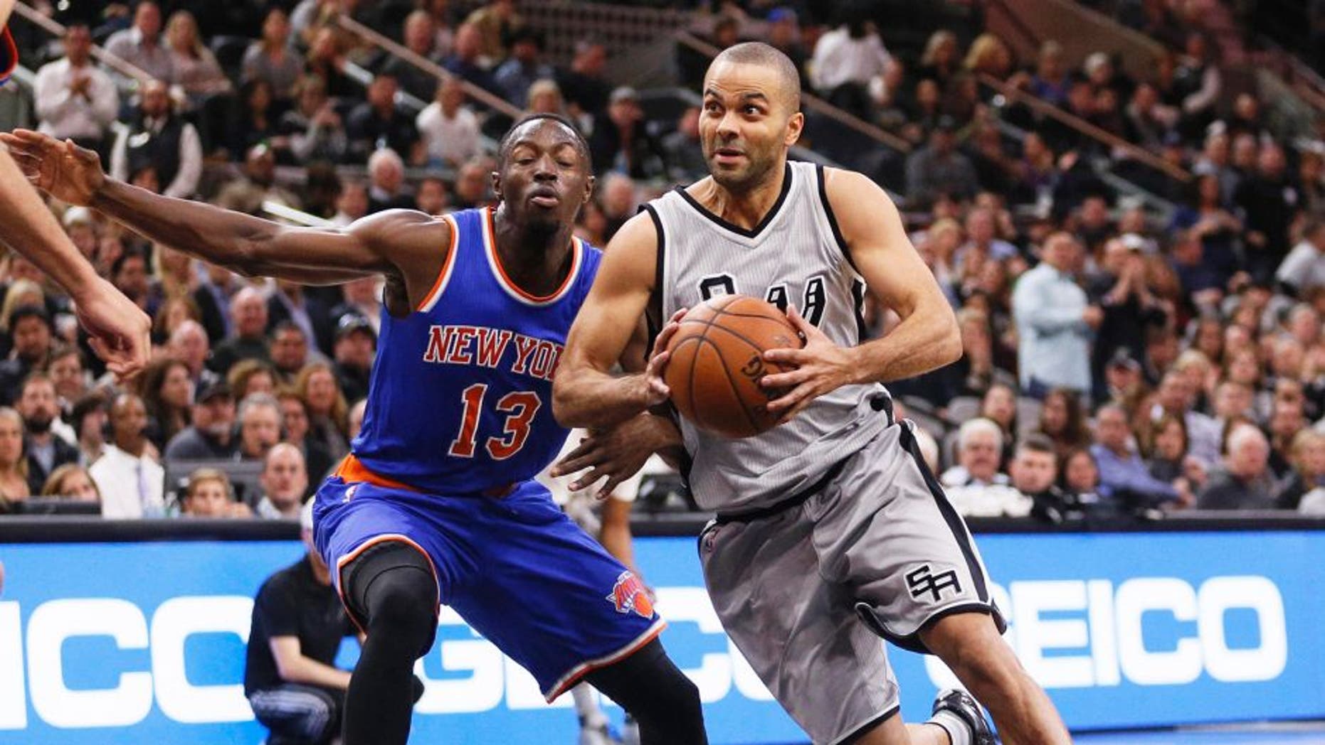 Jan 8, 2016; San Antonio, TX, USA; San Antonio Spurs point guard Tony Parker (right) drives to the basket around New York Knicks point guard Jerian Grant (13) during the first half at AT&T Center. Mandatory Credit: Soobum Im-USA TODAY Sports