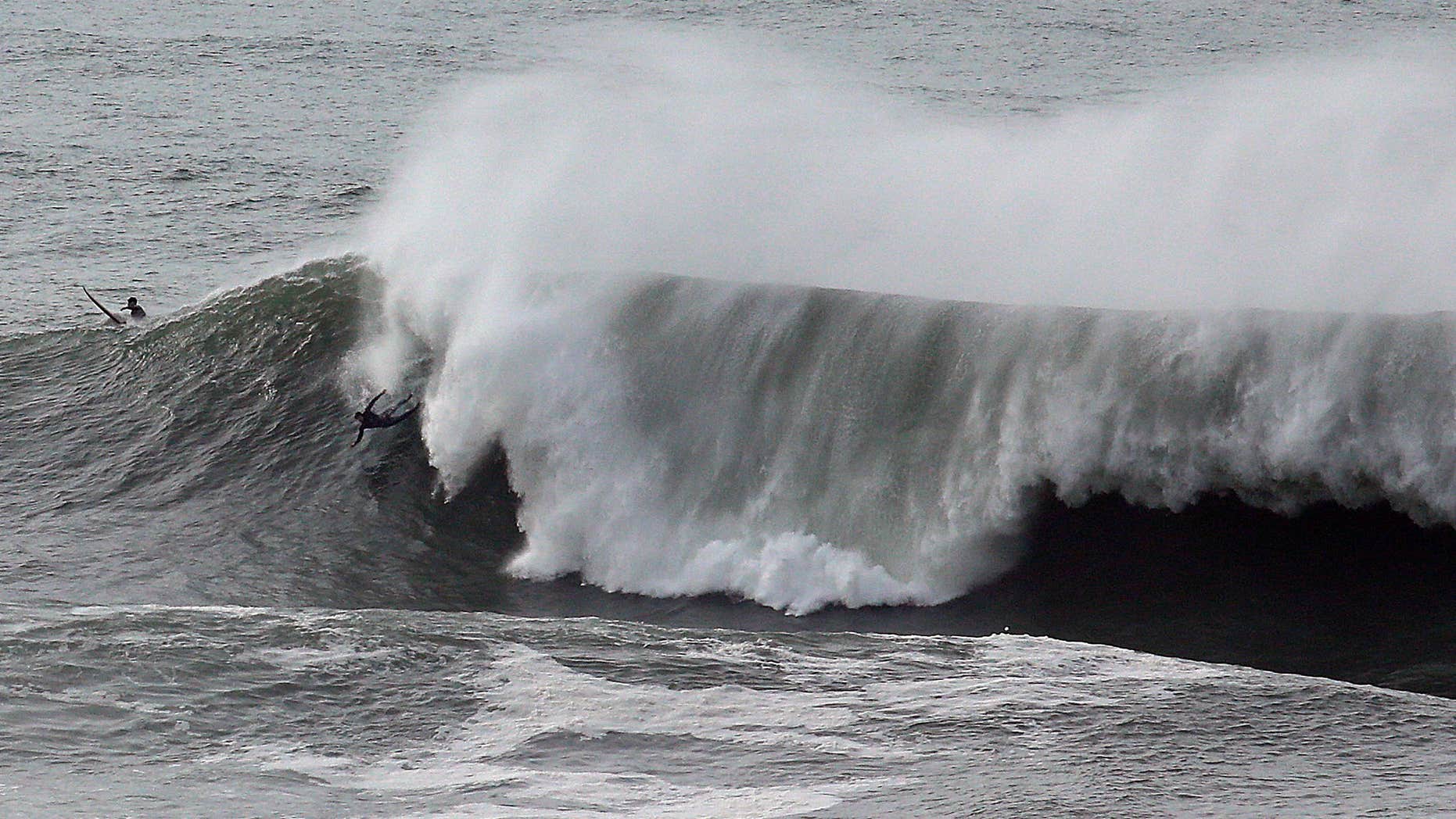 Jan. 8, 2016: A surfer wipes out under a large wave at Mavericks in Half Moon Bay, Calif.