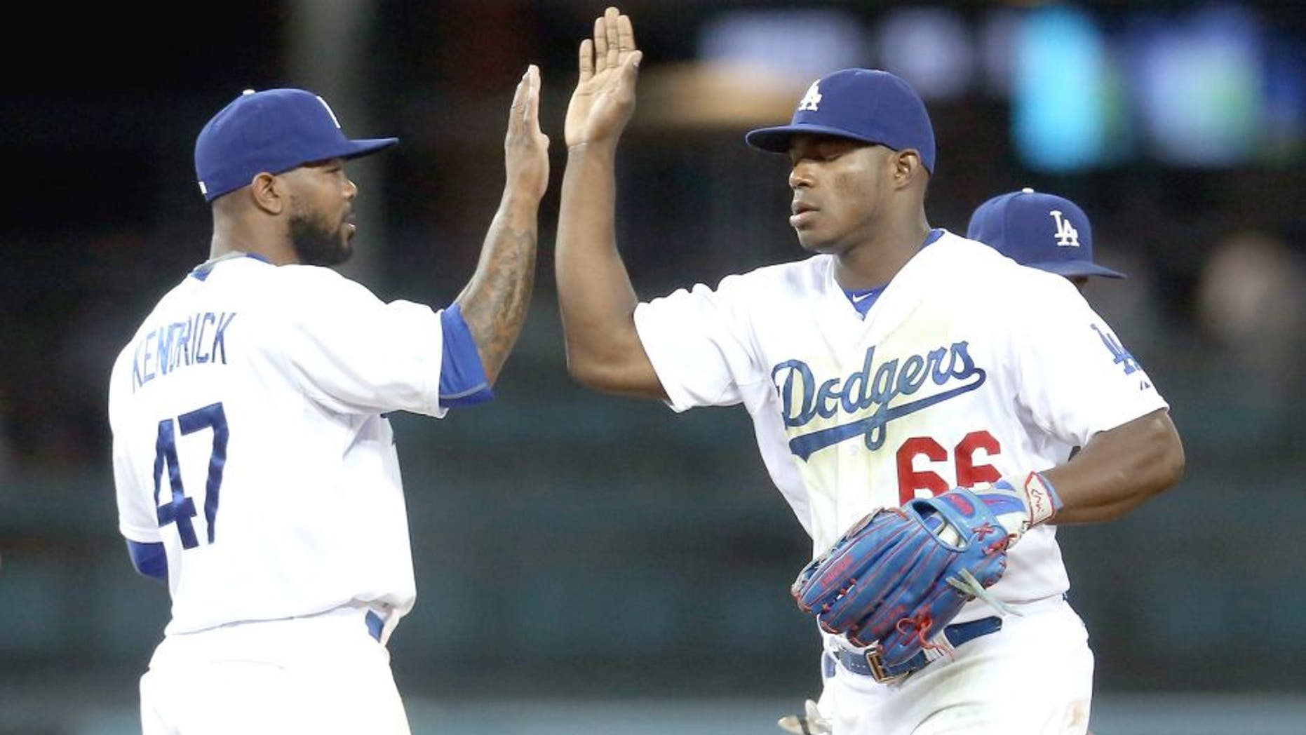 LOS ANGELES, CA - JULY 29: Yasiel Puig #66 and Howie Kendrick #47 of the Los Angeles Dodgers celebrate after the game against the Oakland Athletics at Dodger Stadium on July 29, 2015 in Los Angeles, California. The Dodgers won 10-7. (Photo by Stephen Dunn/Getty Images)