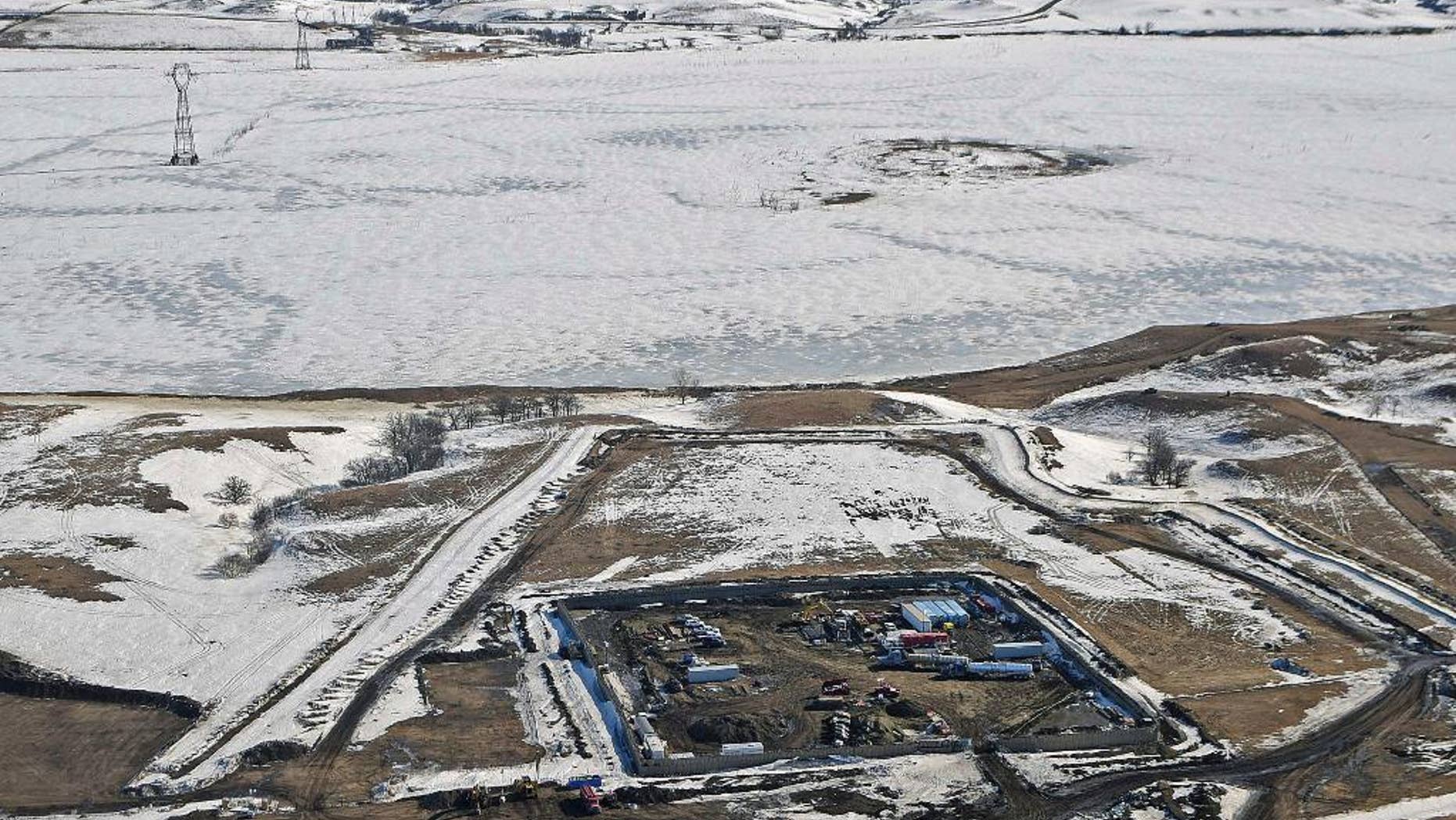 FILE - This Feb. 13, 2017, aerial file photo, shows a site where the final phase of the Dakota Access pipeline is taking place with boring equipment routing the pipeline underground and across Lake Oahe to connect with the existing pipeline in Emmons County near Cannon Ball, N.D. Federal Judge James Boasberg on Tuesday, March 14 denied a request by the Standing Rock and Cheyenne River Sioux to stop oil from flowing while they appeal his earlier decision allowing pipeline construction to finish. (Tom Stromme/The Bismarck Tribune via AP, File)
