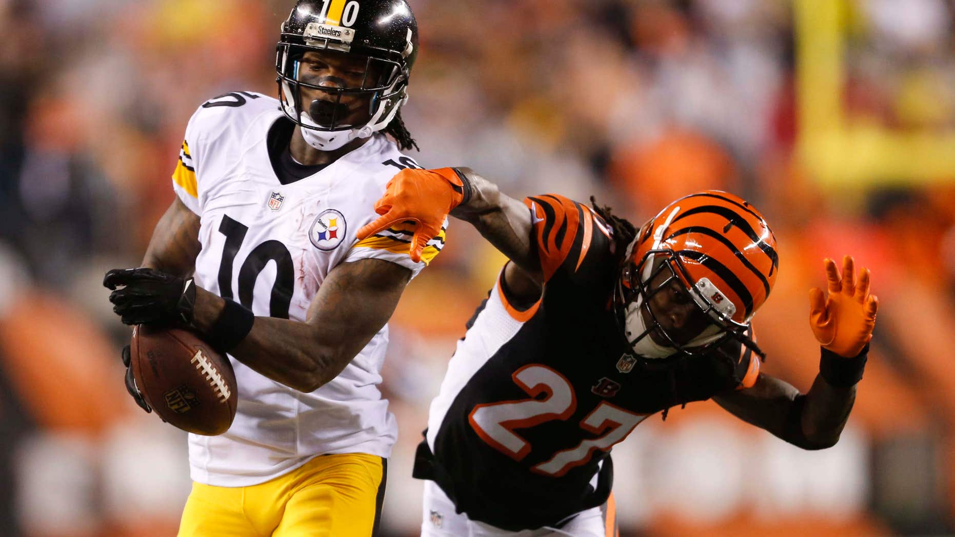 Pittsburgh Steelers wide receiver Martavis Bryant (10) is tackled by Cincinnati Bengals' Dre Kirkpatrick (27) during the second half of an NFL wild-card playoff football game Saturday, Jan. 9, 2016, in Cincinnati.