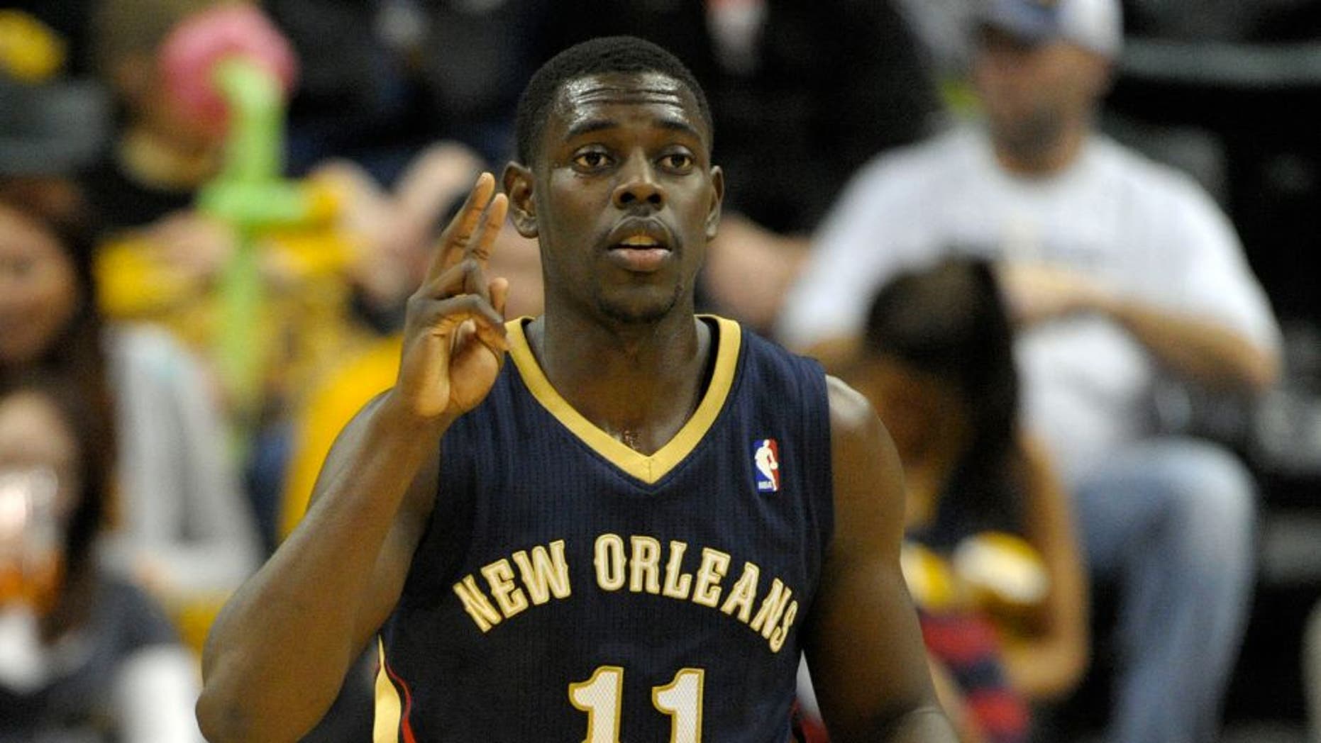 Jan 4, 2014; Indianapolis, IN, USA; New Orleans Pelicans point guard Jrue Holiday (11) signals to his teammates during the second half of the game against the Indiana Pacers at Bankers Life Fieldhouse. Indiana Pacers beat New Orleans Pelicans 99 to 82. Mandatory Credit: Marc Lebryk-USA TODAY Sports
