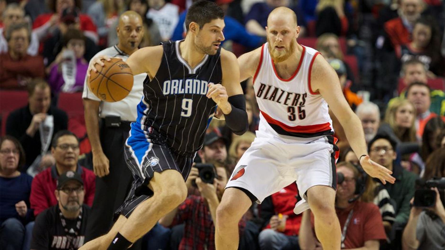 Jan 10, 2015; Portland, OR, USA; Orlando Magic center Nikola Vucevic (9) drives to the basket against Portland Trail Blazers center Chris Kaman (35) at Moda Center at the Rose Quarter. Mandatory Credit: Jaime Valdez-USA TODAY Sports