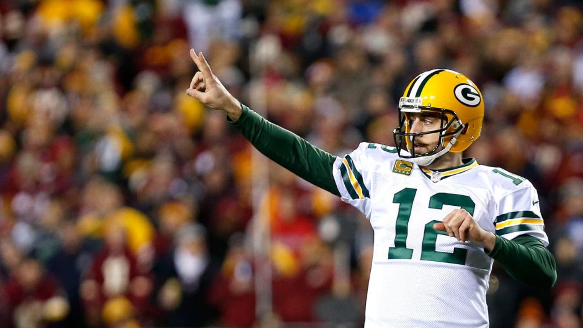 LANDOVER, MD - JANUARY 10: Quarterback Aaron Rodgers #12 of the Green Bay Packers signals to the sideline against the Washington Redskins in the fourth quarter during the NFC Wild Card Playoff game at FedExField on January 10, 2016 in Landover, Maryland. (Photo by Rob Carr/Getty Images)