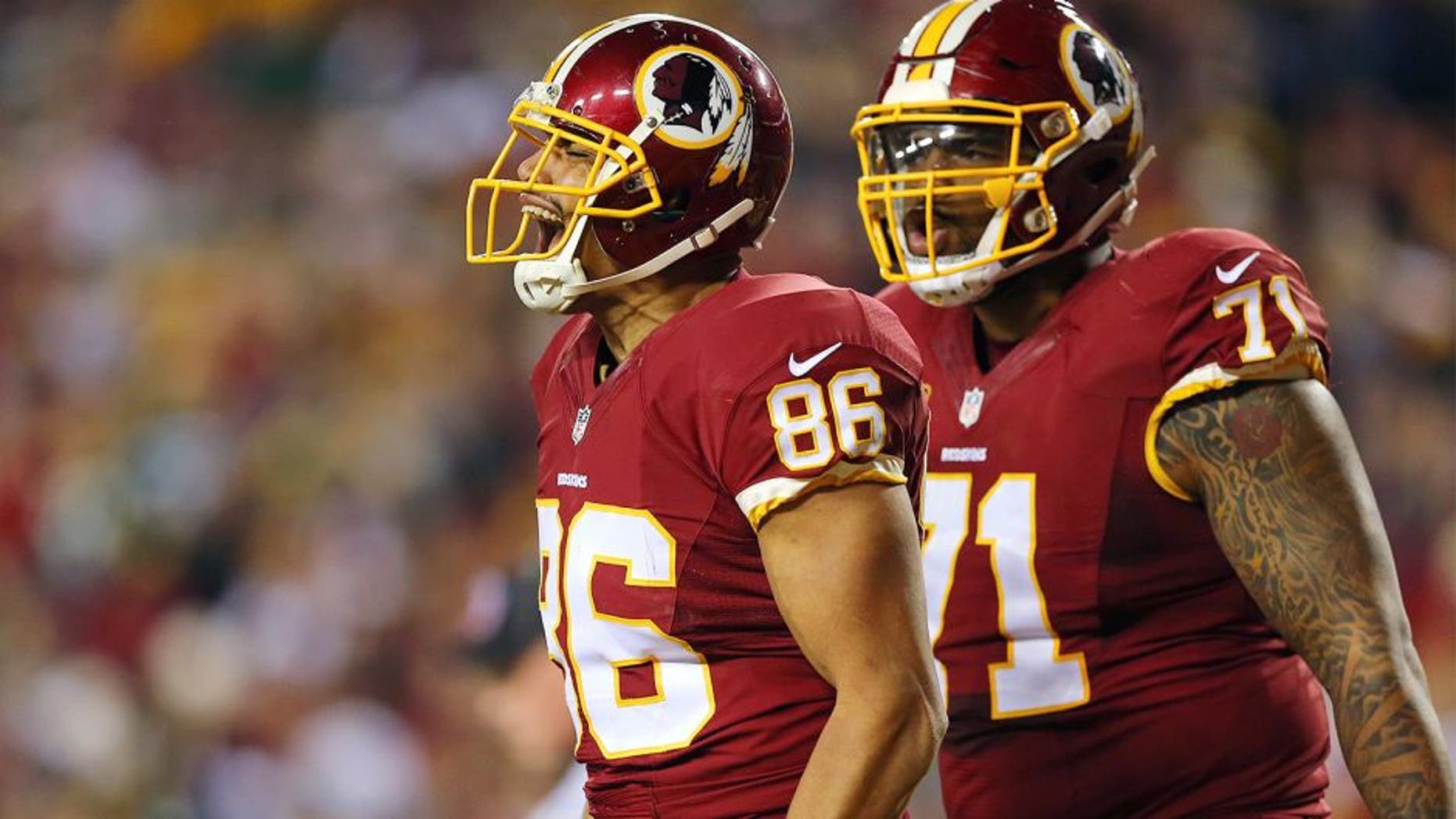 LANDOVER, MD - JANUARY 10: Tight end Jordan Reed #86 of the Washington Redskins celebrates with teammate tackle Trent Williams #71 after scoring a second quarter touchdown against the Green Bay Packers during the NFC Wild Card Playoff game at FedExField on January 10, 2016 in Landover, Maryland. (Photo by Elsa/Getty Images)