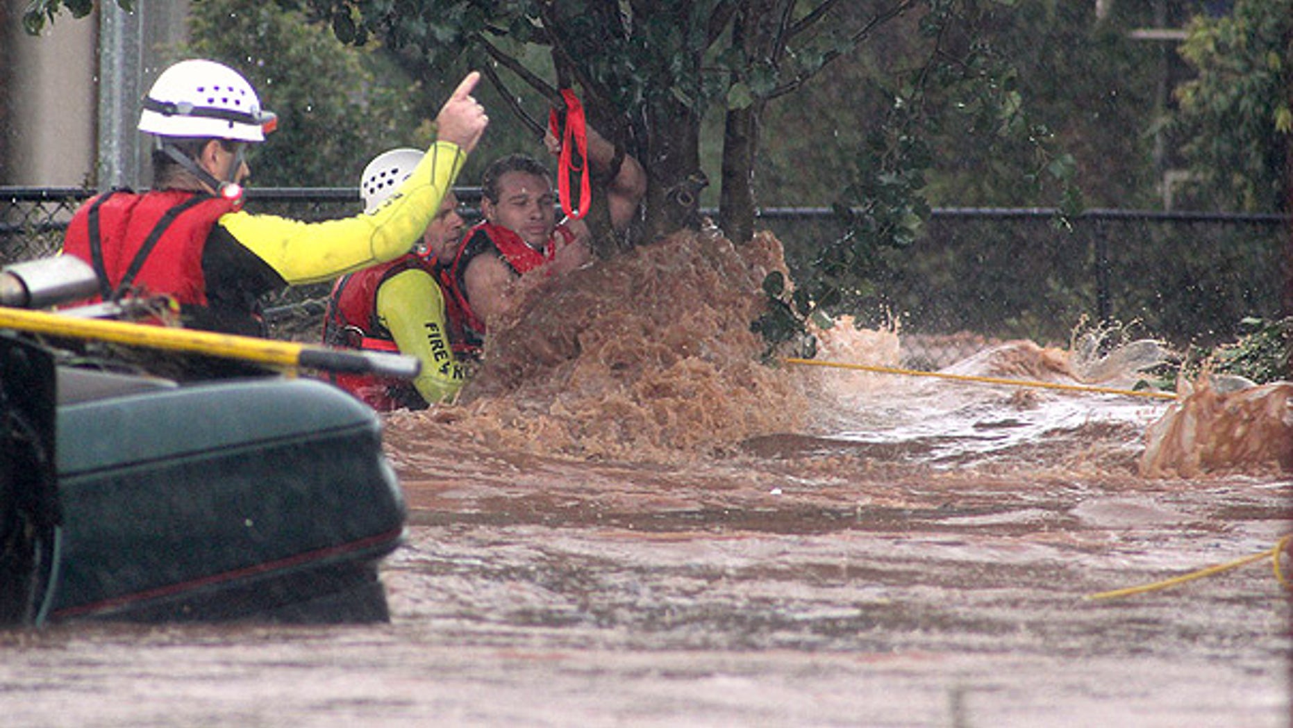 Jan. 10: A man is rescued by emergency workers after he was stranded clinging to a tree during a flash flood in Toowoomba, Australia.