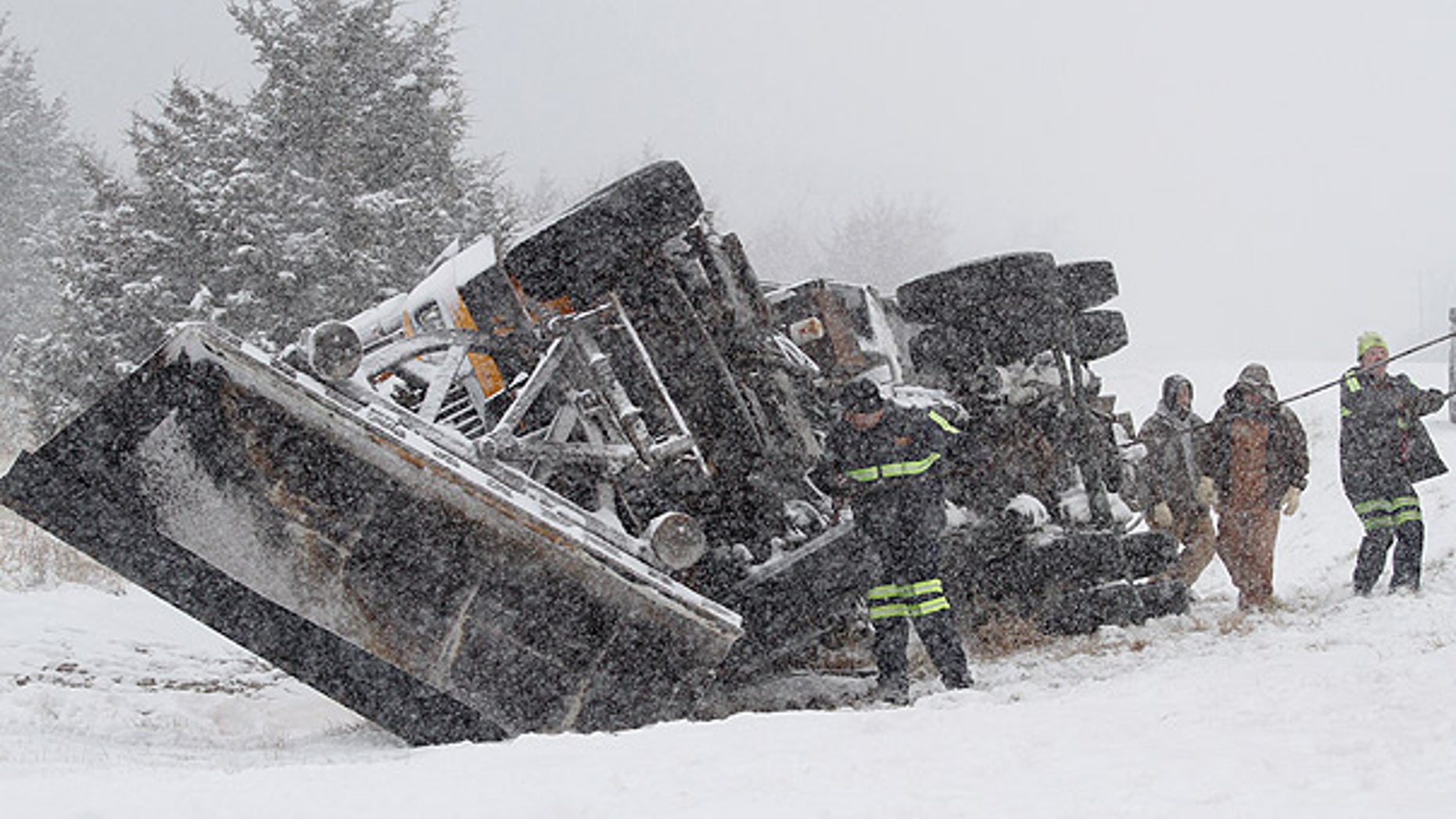 Jan 10: A Douglas County, Kansas, snowplow flips over on an interstate amid an unusually cold storm (AP).