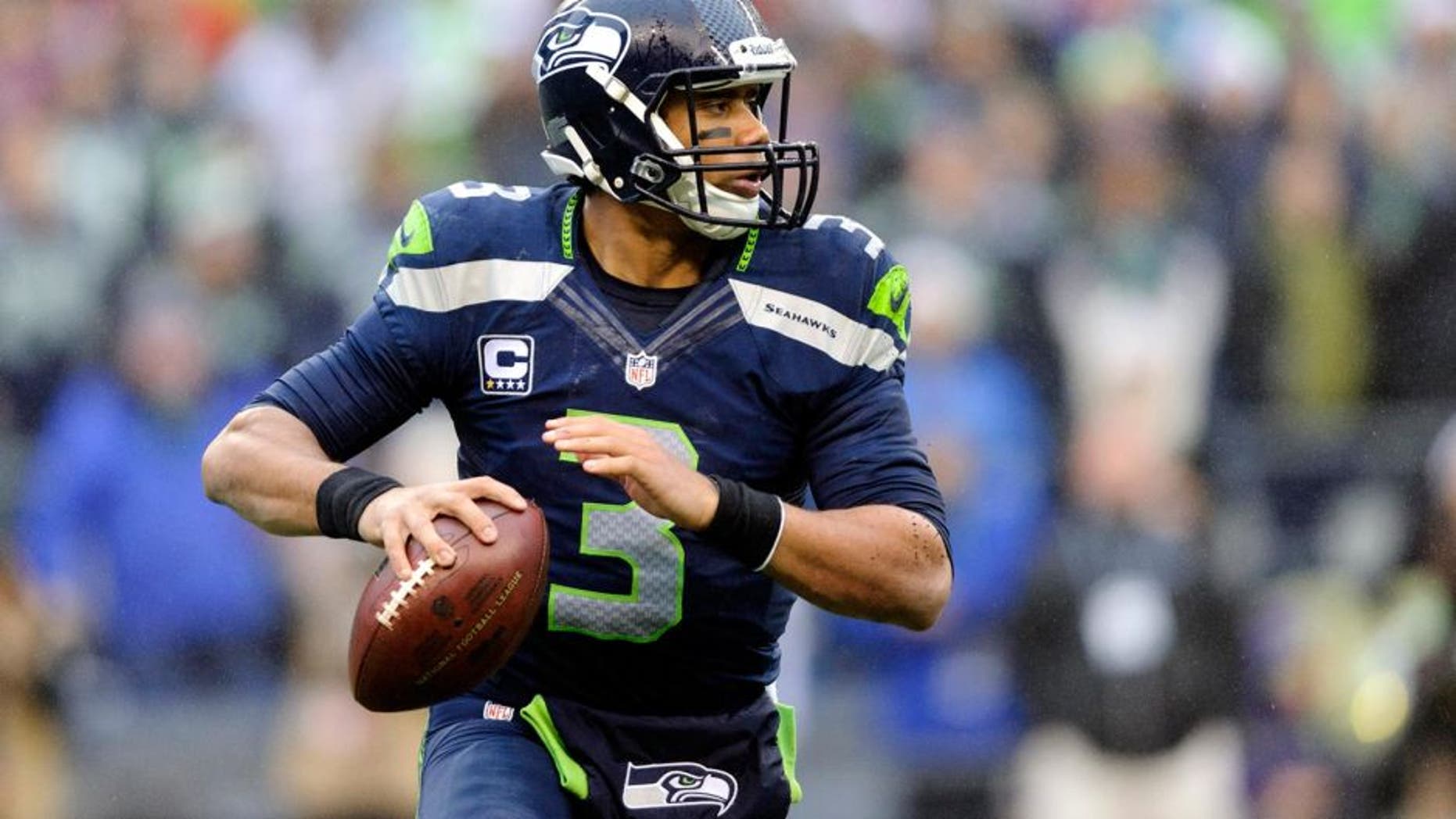 Dec 22, 2013; Seattle, WA, USA; Seattle Seahawks quarterback Russell Wilson (3) looks looks for an open receiver during the first half against the Arizona Cardinals at CenturyLink Field. Mandatory Credit: Steven Bisig-USA TODAY Sports