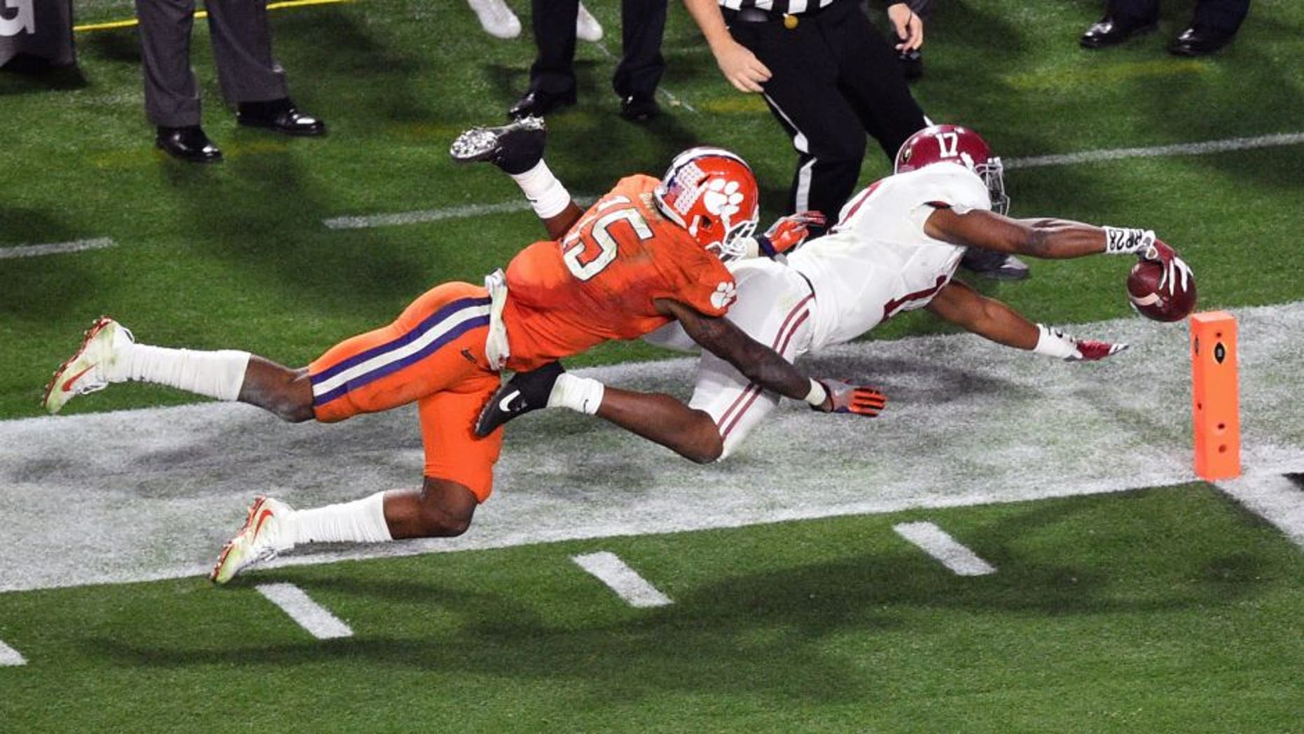 Jan 11, 2016; Glendale, AZ, USA; Alabama Crimson Tide running back Kenyan Drake (17) scores a touchdown while guarded by Clemson Tigers safety T.J. Green (15) during the fourth quarter in the 2016 CFP National Championship at University of Phoenix Stadium. Mandatory Credit: Gary A. Vasquez-USA TODAY Sports