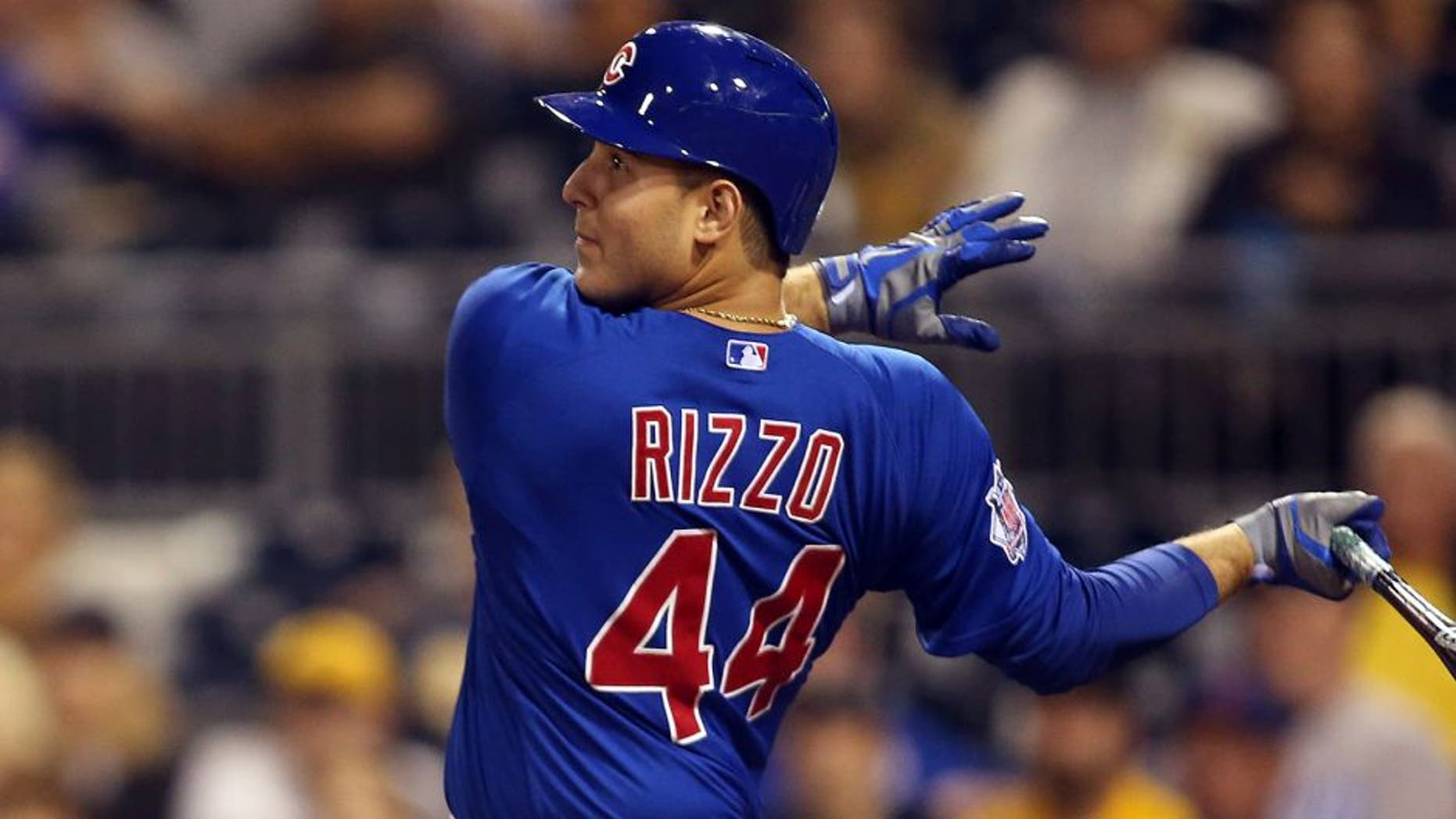 Sep 16, 2015; Pittsburgh, PA, USA; Chicago Cubs first baseman Anthony Rizzo (44) hits a sacrifice fly RBI against the Pittsburgh Pirates during the twelfth inning at PNC Park. The Cubs won 3-2 in twelve innings. Mandatory Credit: Charles LeClaire-USA TODAY Sports