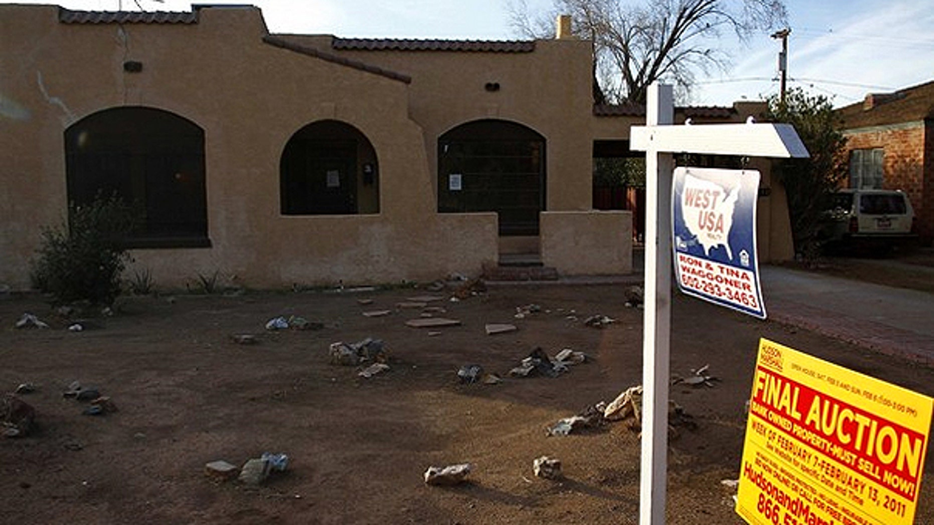 Jan. 4: A realtor and bank-owned sign is displayed near a house for sale in Phoenix, Arizona.