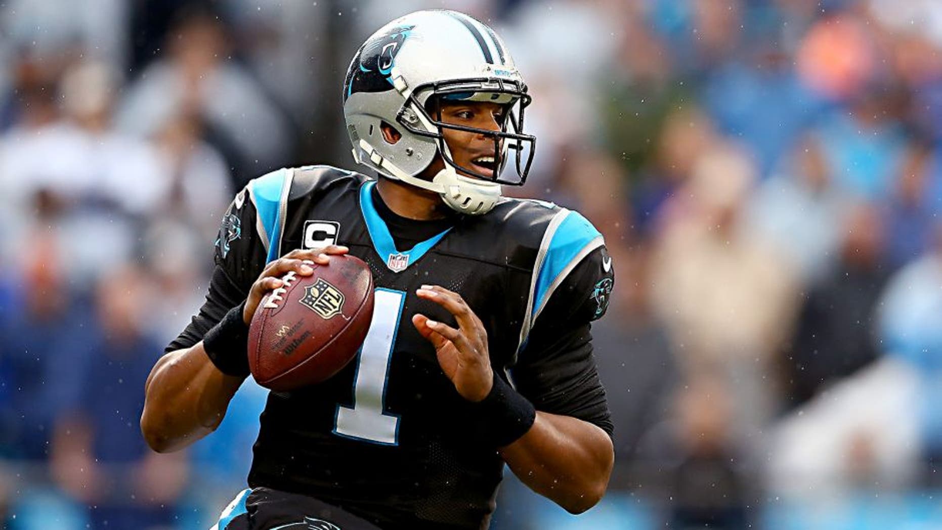 CHARLOTTE, NC - DECEMBER 22: Cam Newton #1 of the Carolina Panthers drops back to pass during their game against the New Orleans Saints at Bank of America Stadium on December 22, 2013 in Charlotte, North Carolina. (Photo by Streeter Lecka/Getty Images)