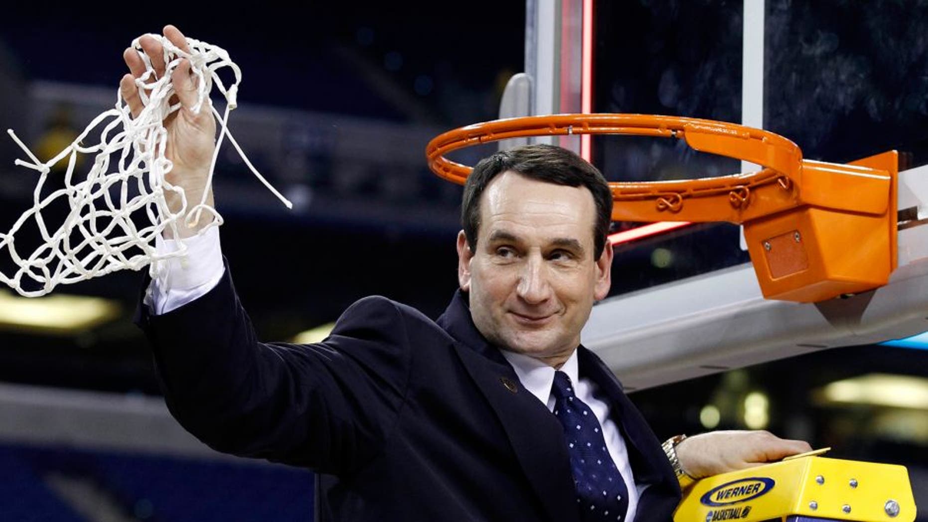 Apr 5, 2010; Indianapolis, IN, USA; Duke Blue Devils head coach Mike Krzyzewski waves to the crowd after cutting down a piece of the net after defeating the Butler Bulldogs 61-59 in the national championship game of the Final Four of the 2010 NCAA mens basketball tournament at Lucas Oil Stadium. Mandatory Credit: Bob Donnan-USA TODAY Sports