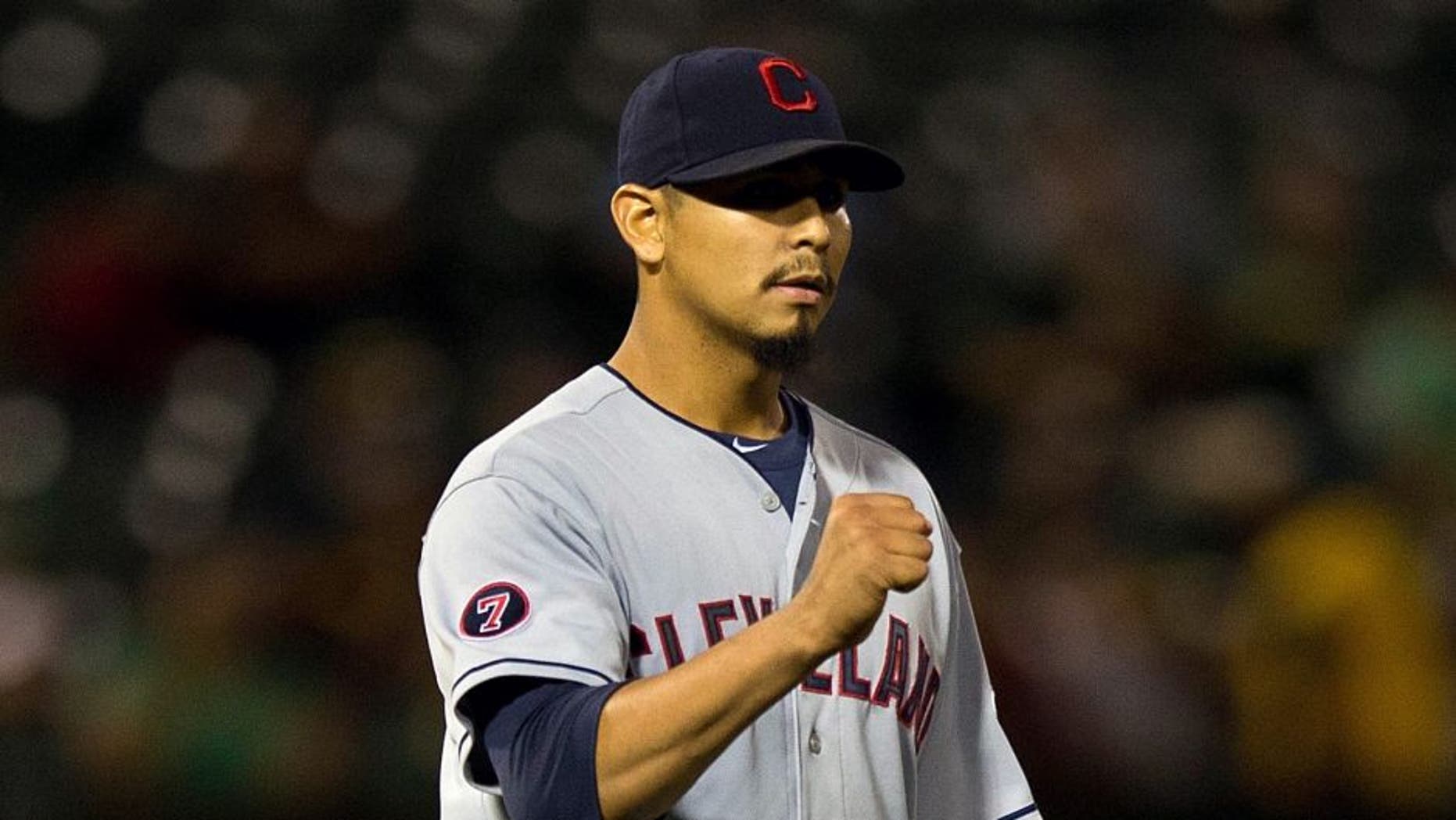 OAKLAND, CA - JULY 30: Carlos Carrasco #59 of the Cleveland Indians celebrates after the game against the Oakland Athletics at O.co Coliseum on July 30, 2015 in Oakland, California. The Cleveland Indians defeated the Oakland Athletics 3-1. (Photo by Jason O. Watson/Getty Images)