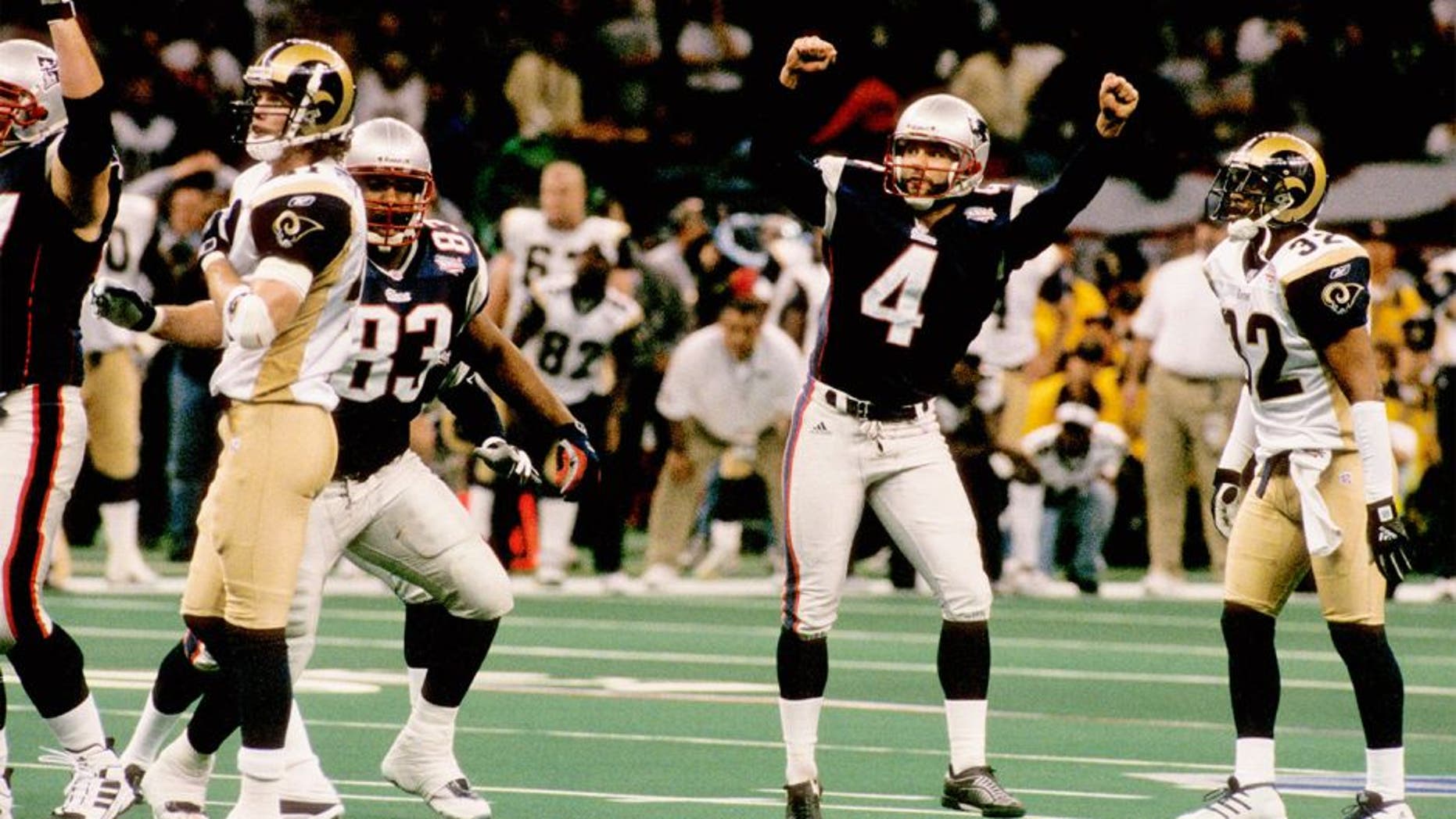 New England Patriots kicker Adam Vinatieri (4) celebrates his 48-yard game-winning kick during Super Bowl XXXVI, a 20-17 victory over the St. Louis Rams on February 3, 2002, at the Louisiana Superdome in New Orleans, Louisiana. (Photo by Sylvia Allen/Getty Images)