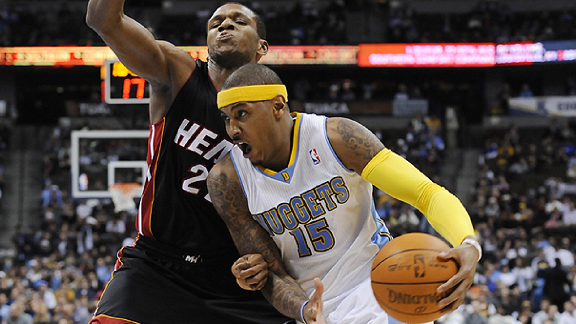 Jan. 13: Denver Nuggets forward Carmelo Anthony (15) drives past Miami Heat forward James Jones (22) during the third quarter of an NBA basketball game in Denver.