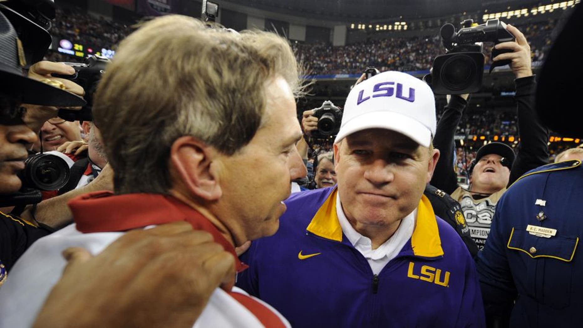 Jan 9, 2012; New Orleans, LA, USA; LSU Tigers head coach Les Miles (right) shakes hands with Alabama Crimson Tide head coach Nick Saban after the 2012 BCS National Championship game at the Mercedes-Benz Superdome. Mandatory Credit: John David Mercer-USA TODAY Sports