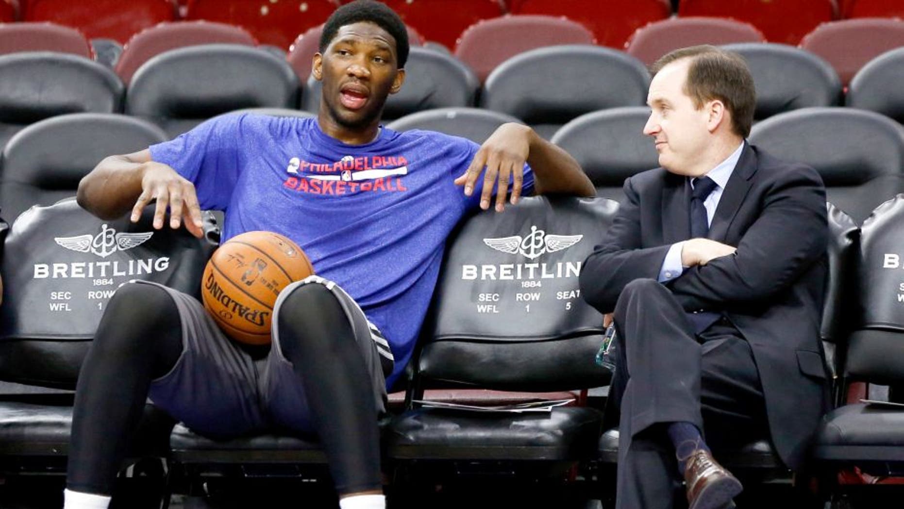 Dec 15, 2014; Philadelphia, PA, USA; Injured Philadelphia 76ers center Joel Embiid (left) talks with general manager and president Sam Hinkie (right) before a game against the Boston Celtics at Wells Fargo Center. Mandatory Credit: Bill Streicher-USA TODAY Sports