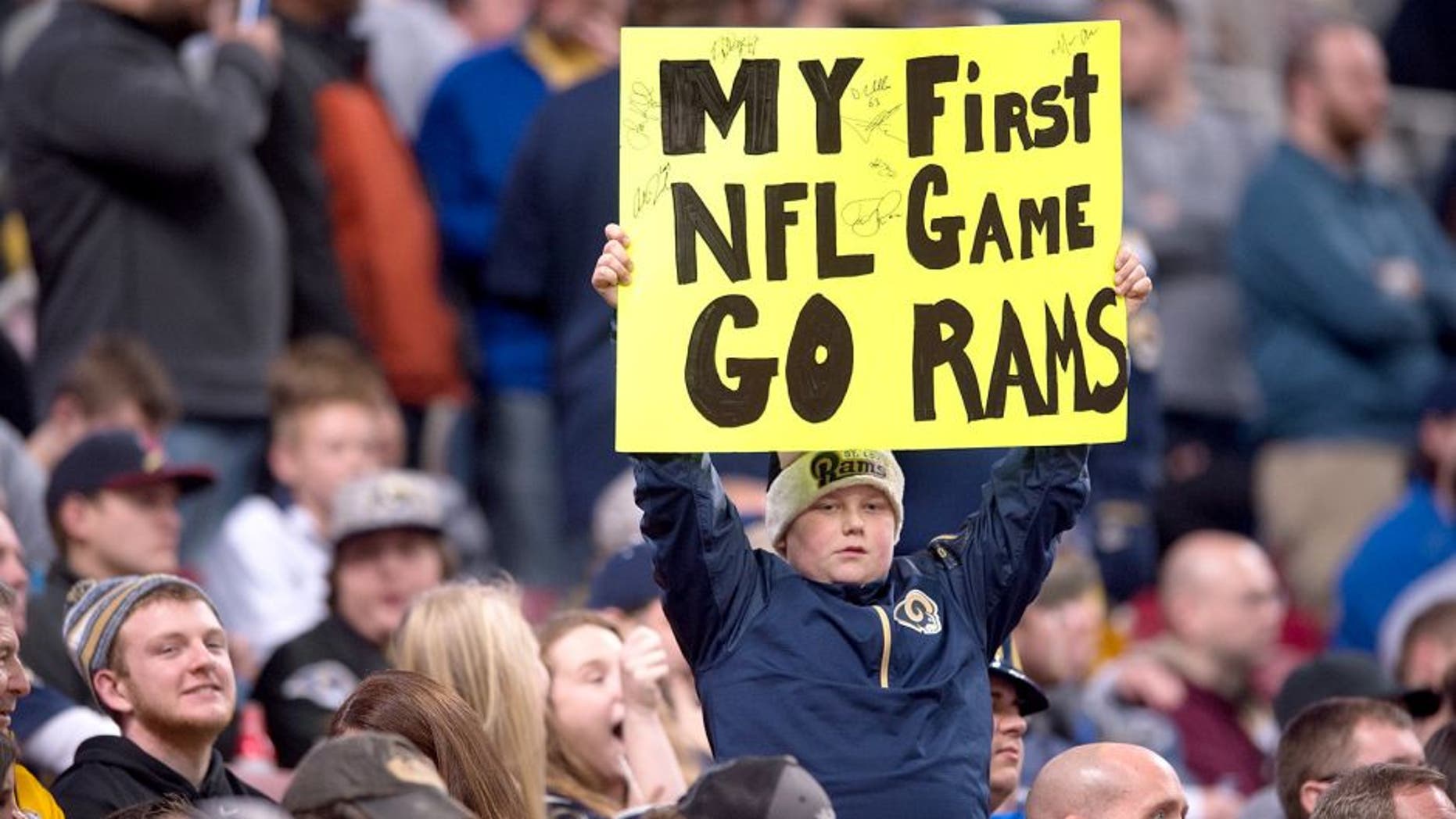 ST. LOUIS, MO - DECEMBER 17: A young St. Louis Rams fan holds a sign in the second quarter go a game against the Tampa Bay Buccaneers at the Edward Jones Dome on December 17, 2015 in St. Louis, Missouri. (Photo by Michael B. Thomas/Getty Images)