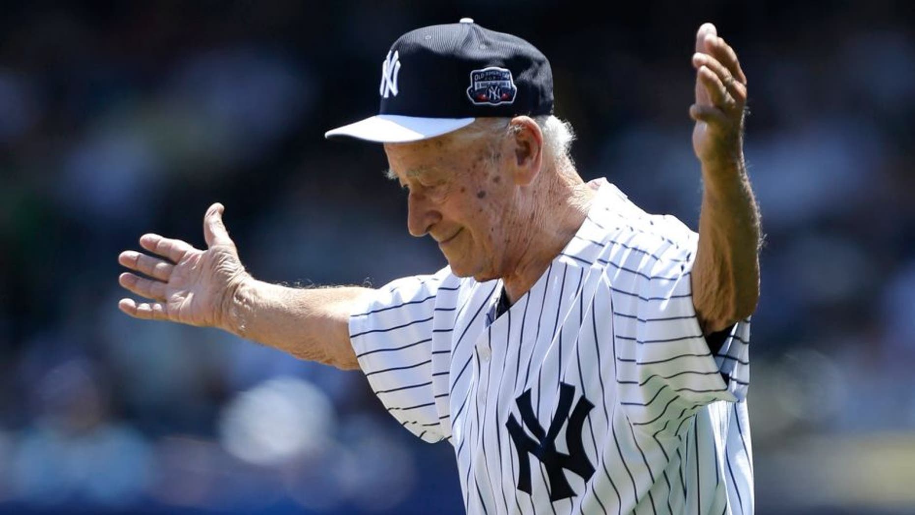 FILE- In this June 23, 2013, file photo, former New York Yankees relief pitcher and scout Luis Arroyo acknowledges the crowd as he is introduced to fans before the Yankees 67th annual Old Timers Day baseball game at Yankee Stadium in New York. The Yankees said Arroyo's daughter, Milagros, told the team Wednesday, Jan. 13, 2016, that Arroyo had died earlier in the day in Puerto Rico. He was 88. (AP Photo/Kathy Willens, File)