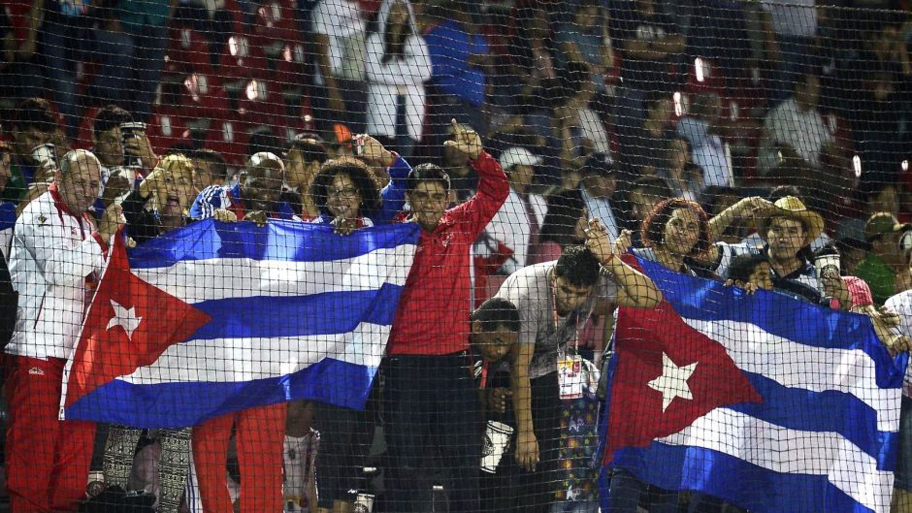 Cuban fans celebrate after winning the Gold medal against Nicaragua during the final match of Baseball, at the XXII Central American and Caribbean Games, in Veracruz, Mexico, on November 21, 2014. The Games bring together nearly 8,000 athletes from 31 countries and run through November 30. AFP PHOTO/RONALDO SCHEMIDT (Photo credit should read RONALDO SCHEMIDT/AFP/Getty Images)