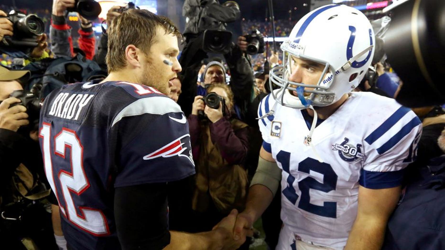 FOXBORO, MA - JANUARY 11: (L-R) Tom Brady #12 of the New England Patriots shakes hands with Andrew Luck #12 of the Indianapolis Colts after their AFC Divisional Playoff game at Gillette Stadium on January 11, 2014 in Foxboro, Massachusetts. The New England Patriots defeated the Indianapolis Colts 43 to 22. (Photo by Al Bello/Getty Images)