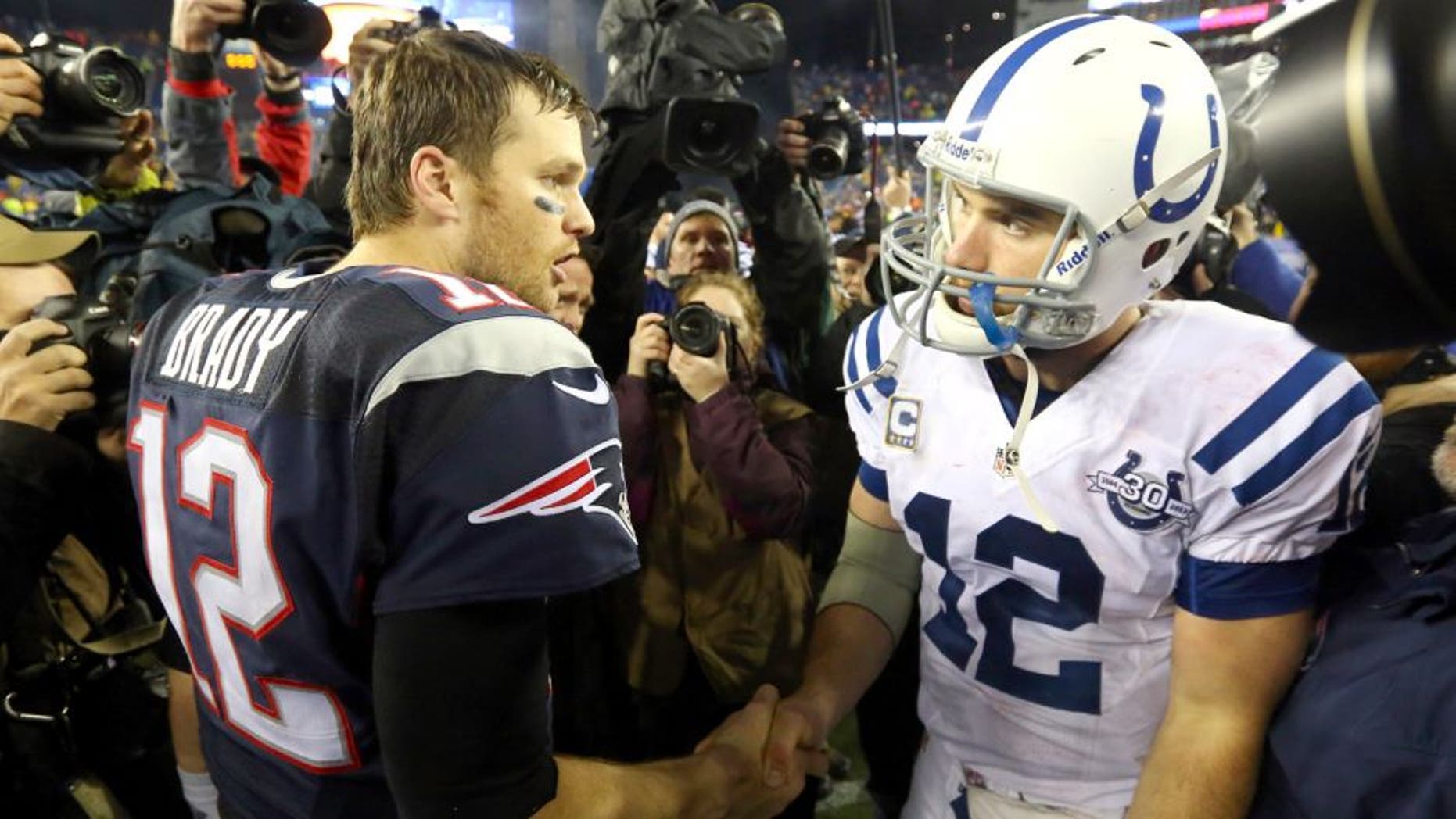FOXBORO, MA - JANUARY 11: (L-R) Tom Brady #12 of the New England Patriots shakes hands with Andrew Luck #12 of the Indianapolis Colts after their AFC Divisional Playoff game at Gillette Stadium on January 11, 2014 in Foxboro, Massachusetts. The New England Patriots defeated the Indianapolis Colts 43 to 22. (Photo by Al Bello/Getty Images)